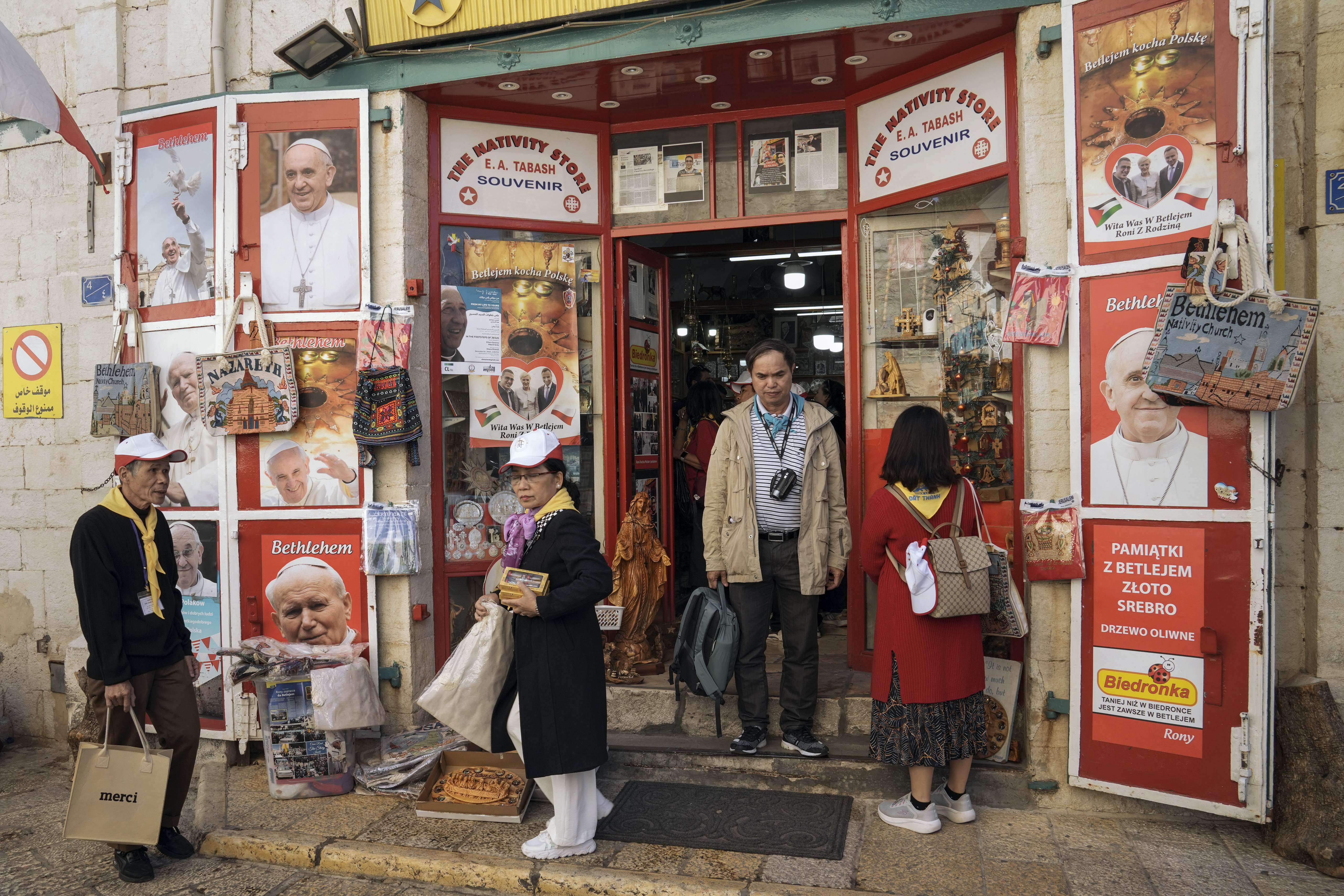 Tourists visit a gift shop in Manger Square
