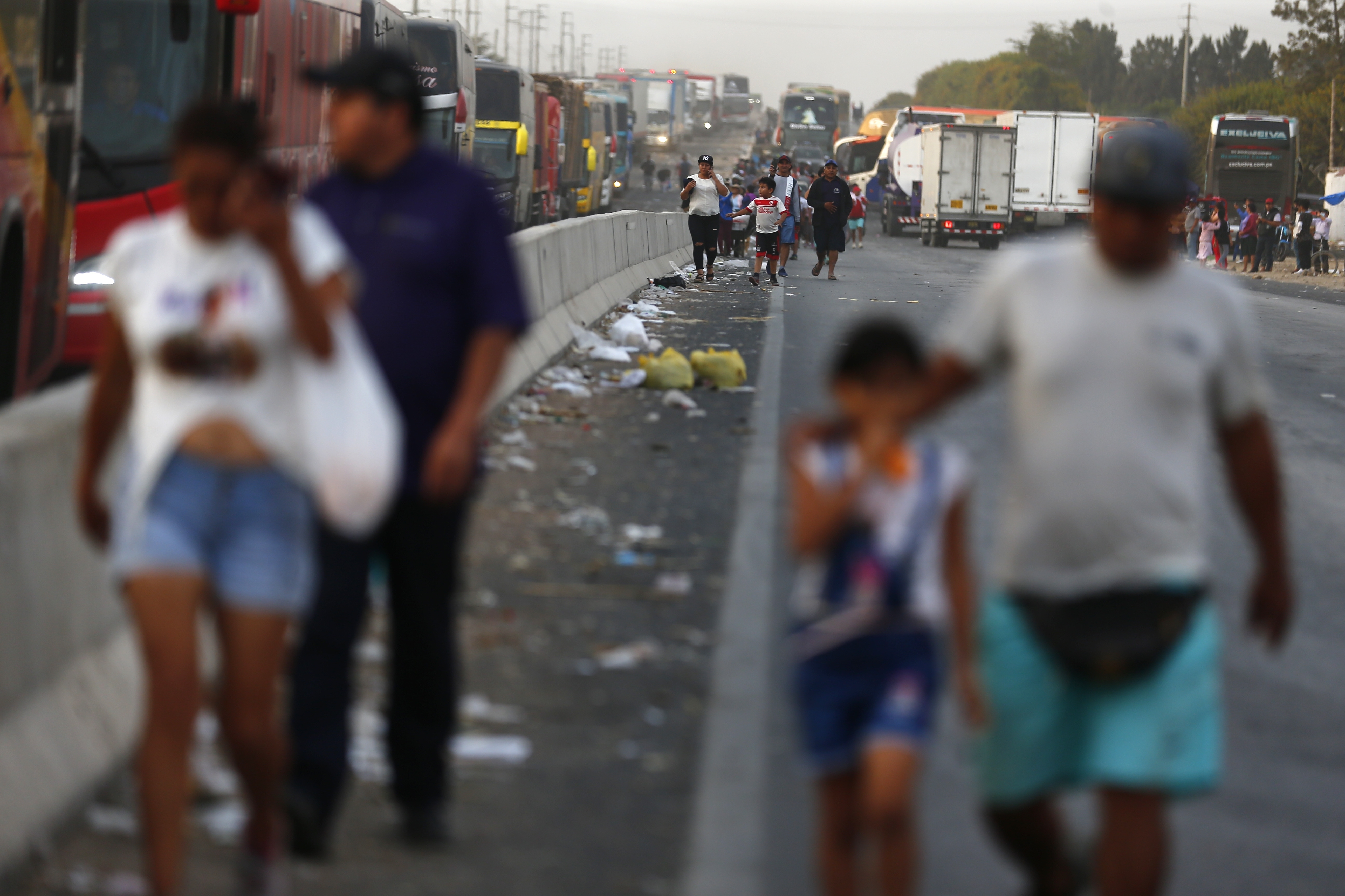 People walk along the Pan-American North Highway