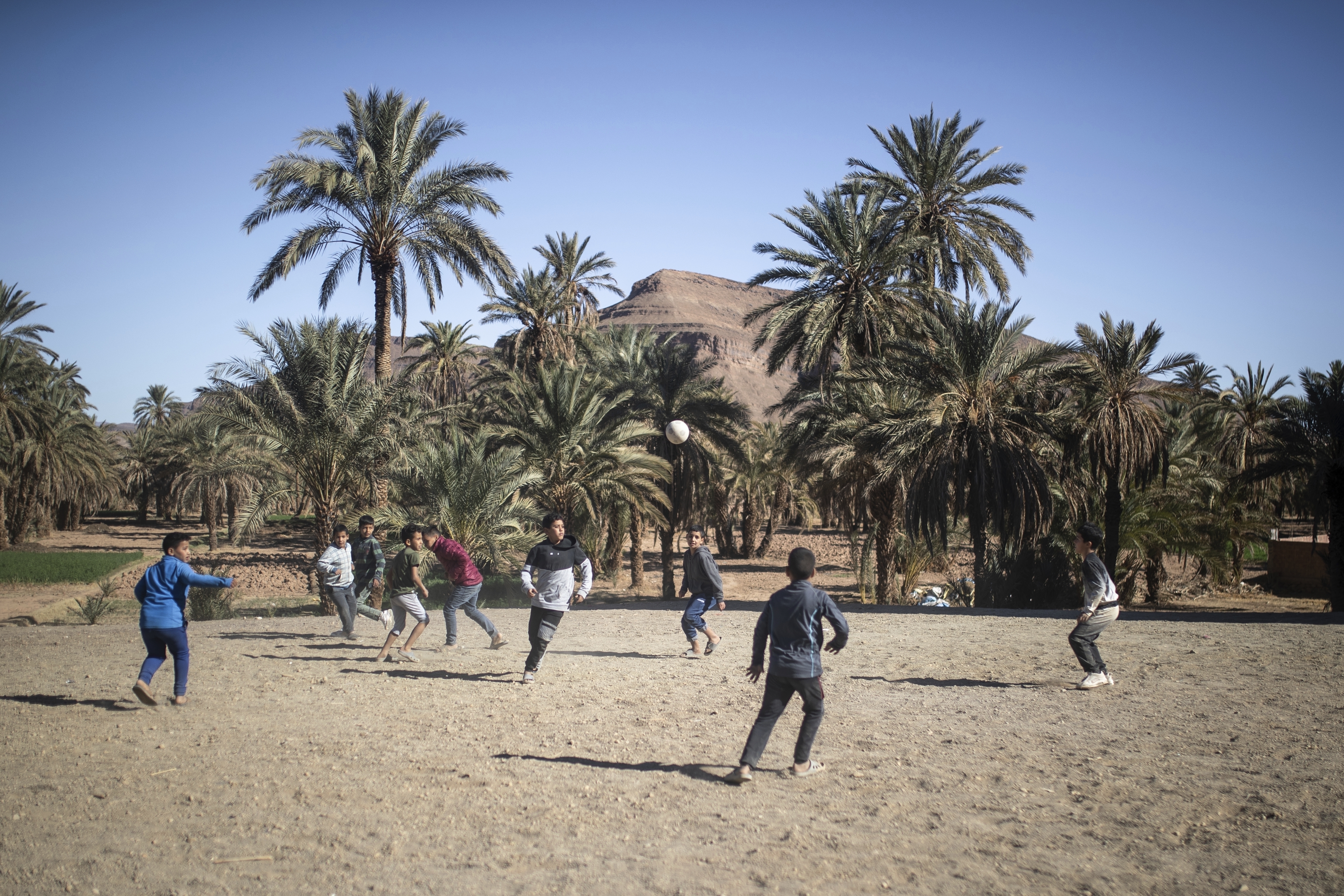 Boys play football in the Alnif oasis town,