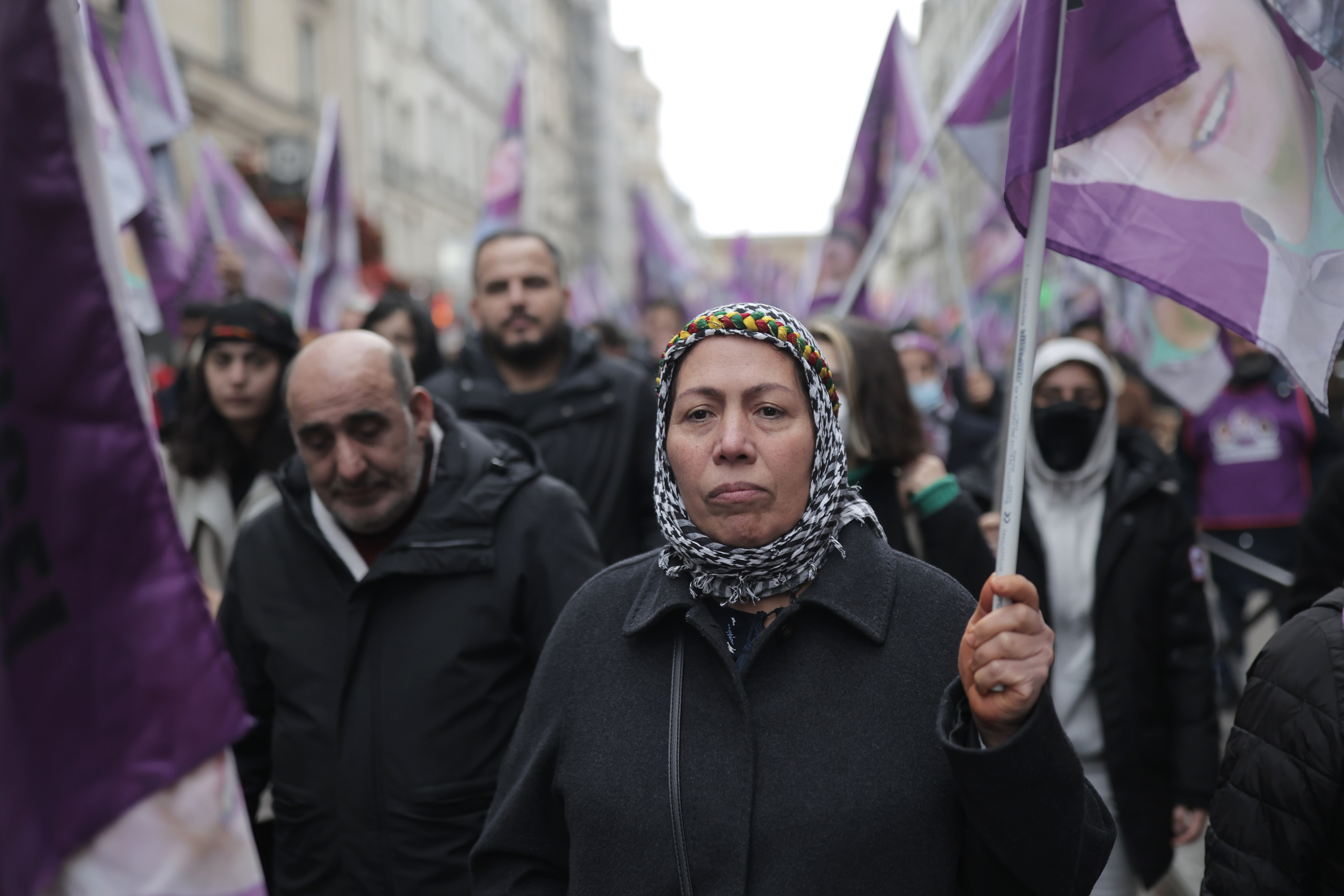 Kurdish activists hold flags during a march