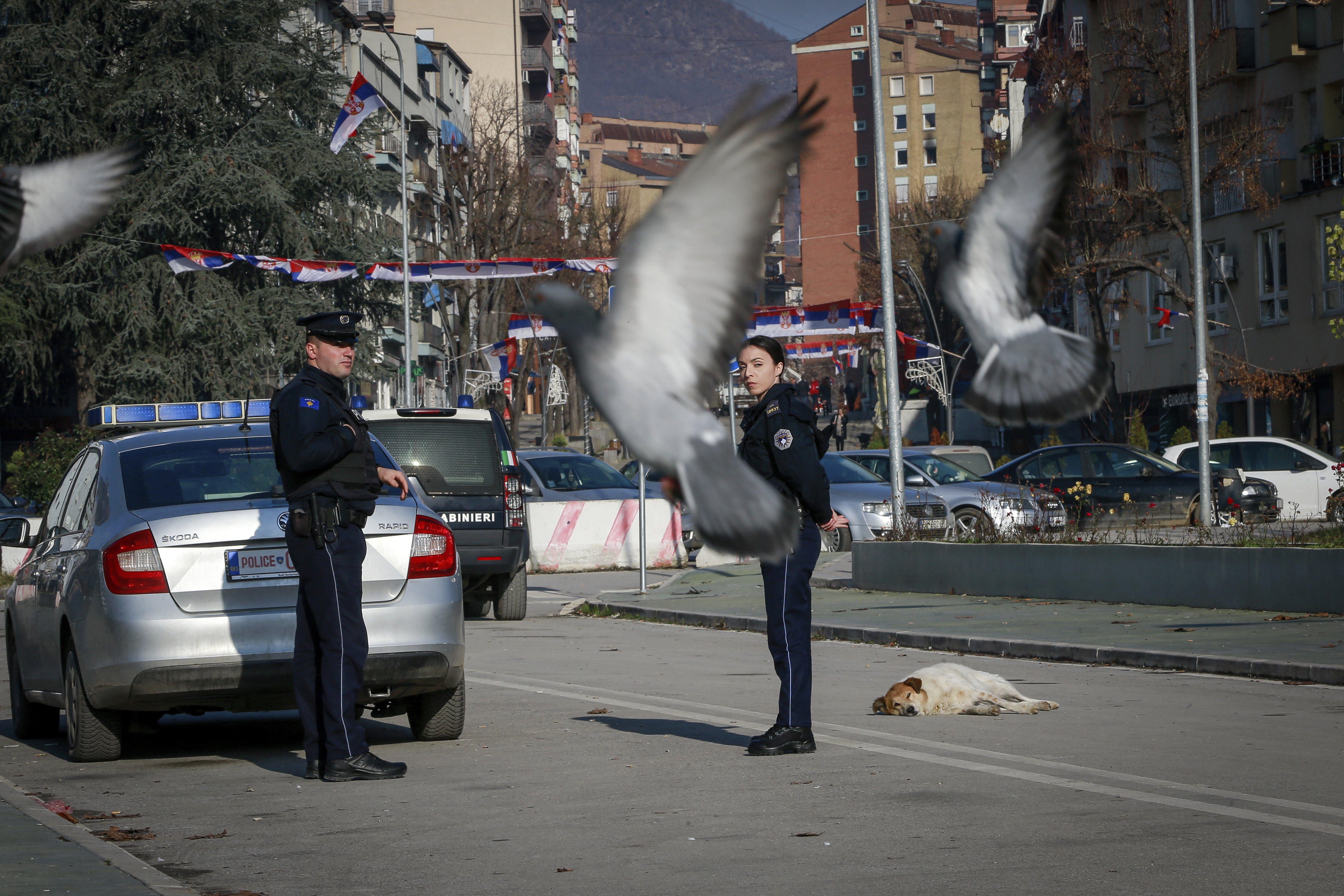 Kosovo police officers patrol on the bridge dividing southern Albanian and the northern, Serb-dominated part of ethnically divided town of Mitrovica
