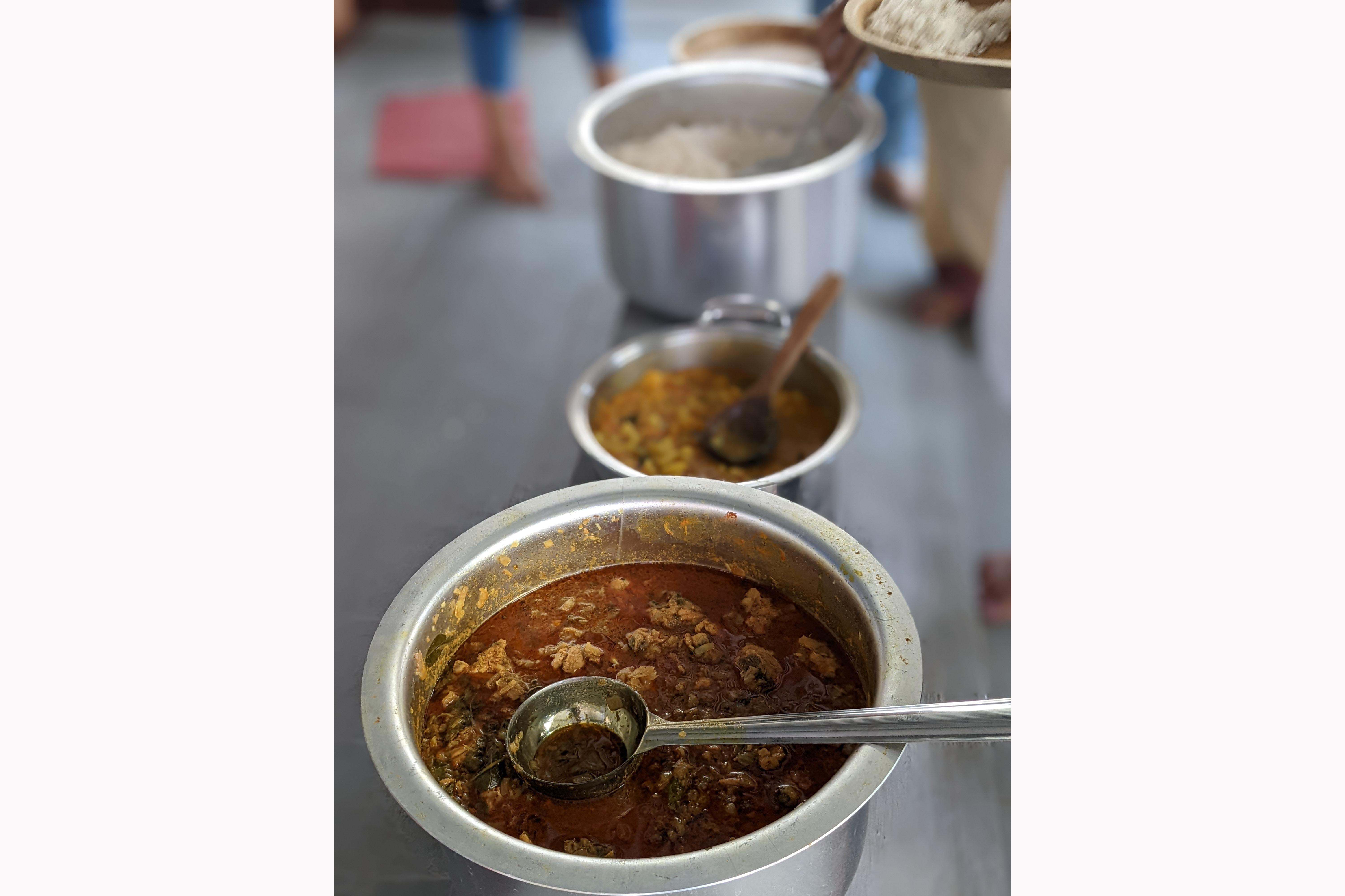 A photo of a line of pots holding the different curries and rice that will be eaten by Sri Vamsi's guests