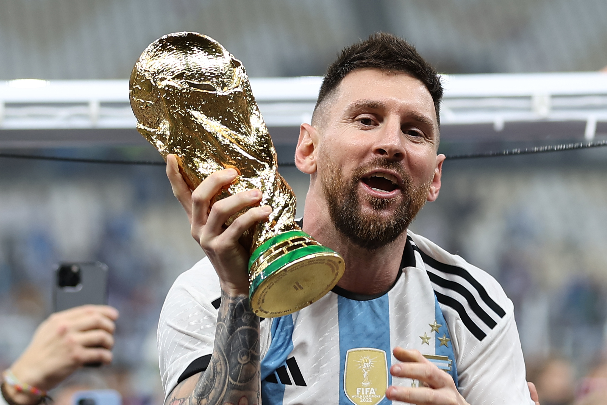 Lionel Messi holds the World Cup aloft after his side's victory over France | Argentina v France