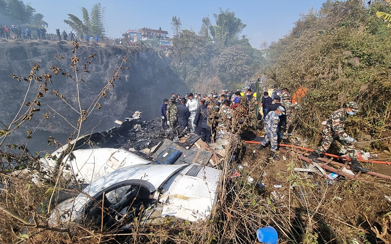 Rescue teams work at the wreckage of a Yeti Airlines ATR72 aircraft after it crashed in Pokhara, Nepal, 15 January 2023