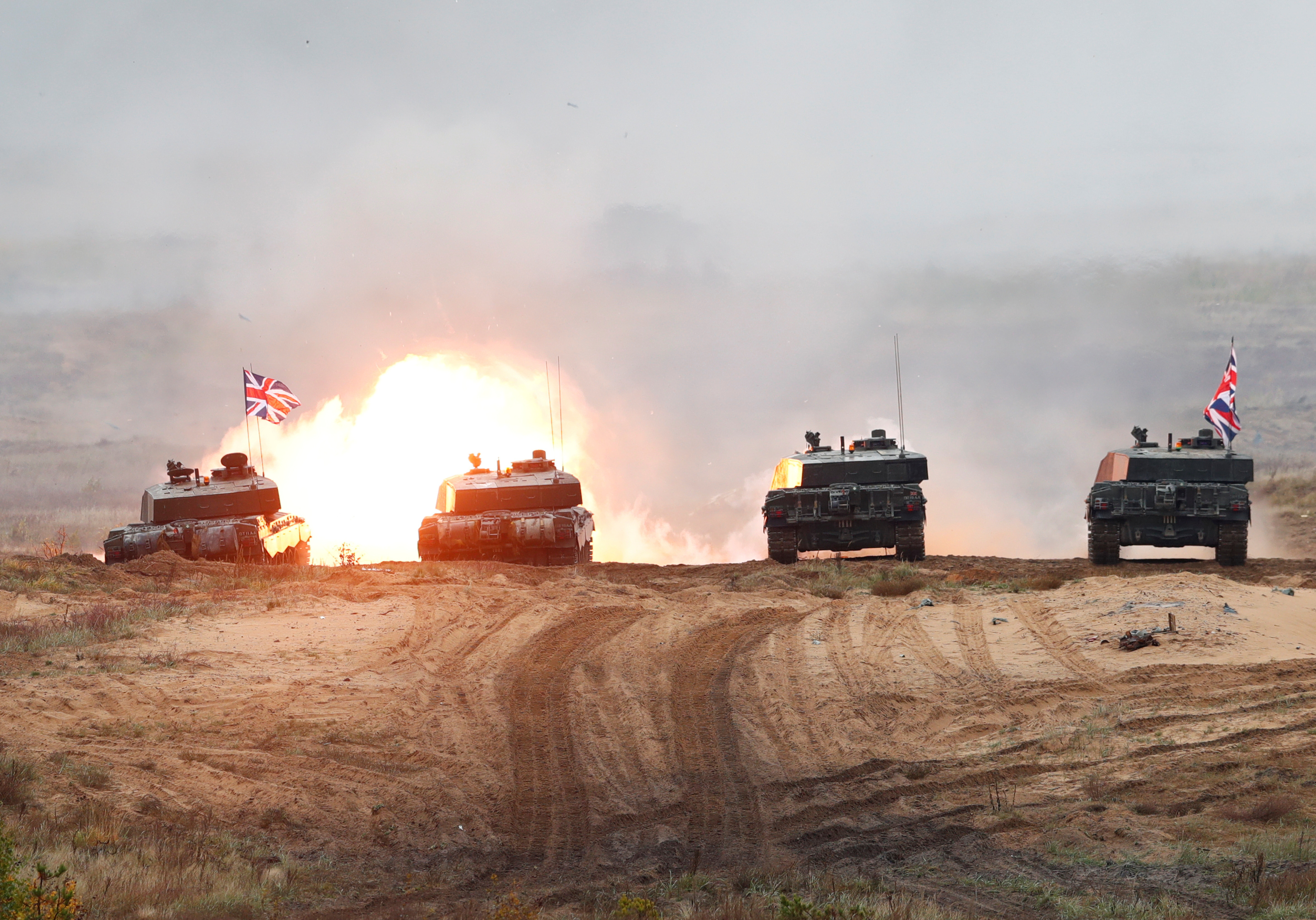 A British Army Challenger 2 tank fires during a NATO exercise in Adazi, Latvia.