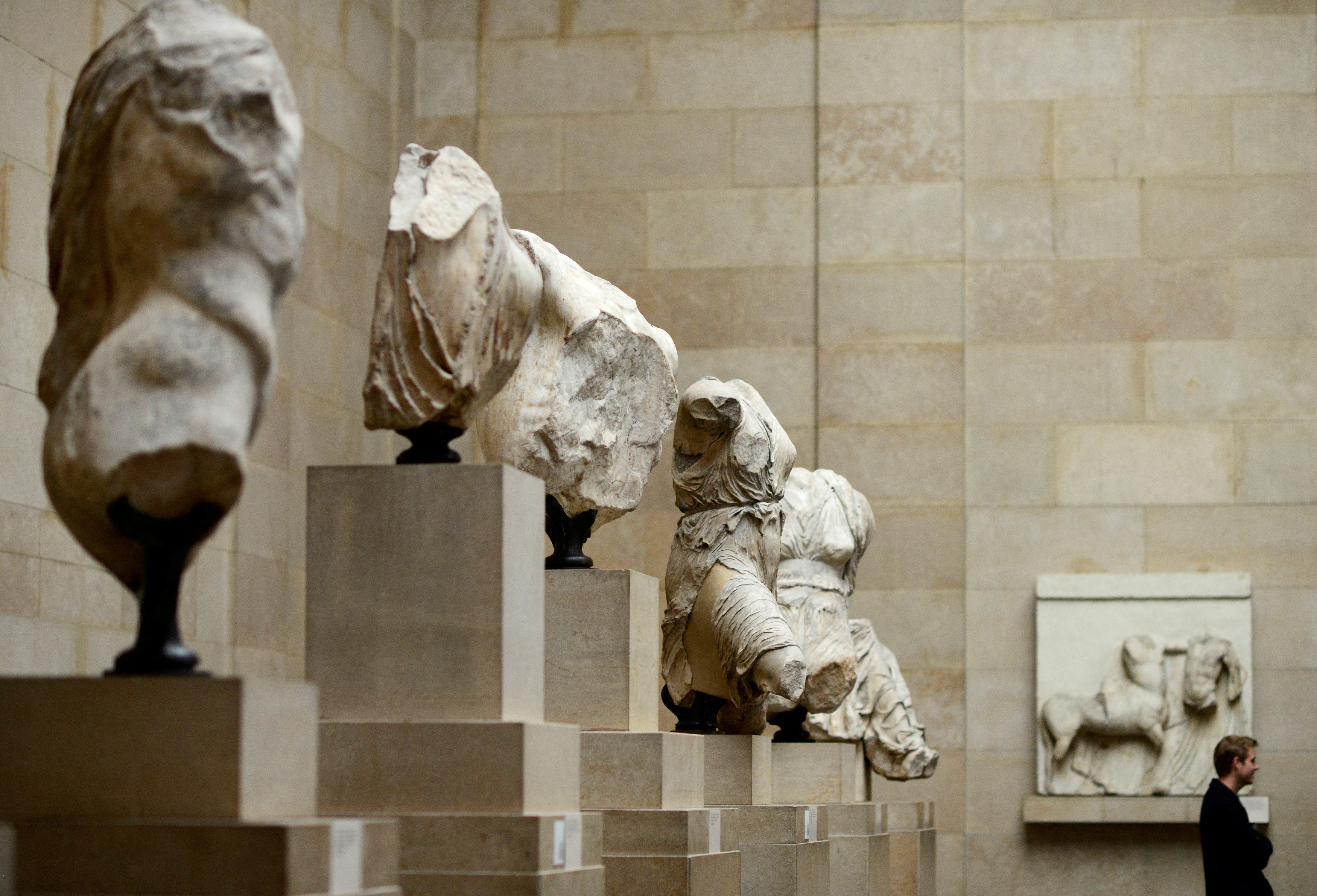 A man looks at the Parthenon Marbles