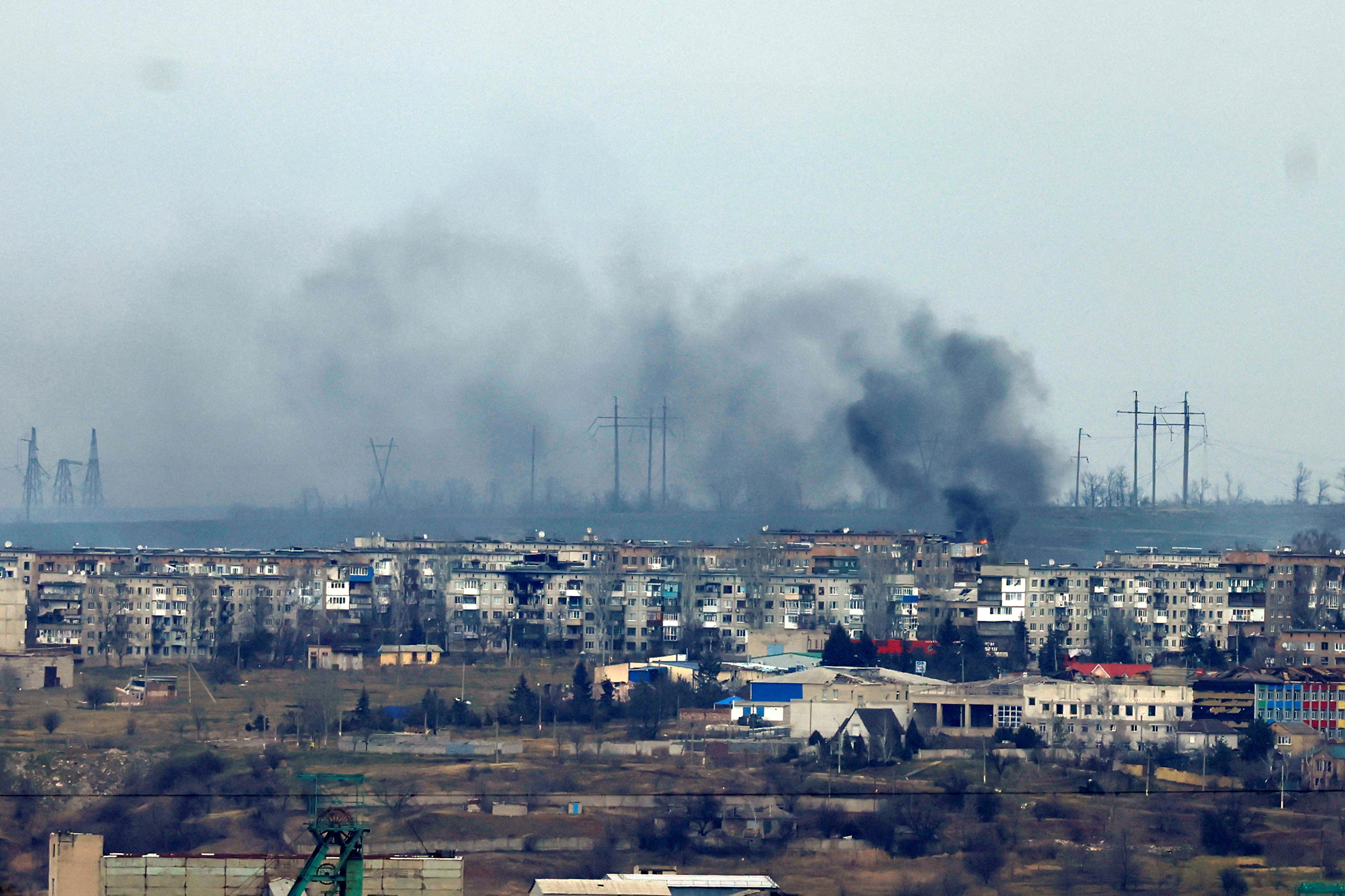 Columns of black and white smoke rising above residential apartment blocks in the town of Soledar, Ukraine.