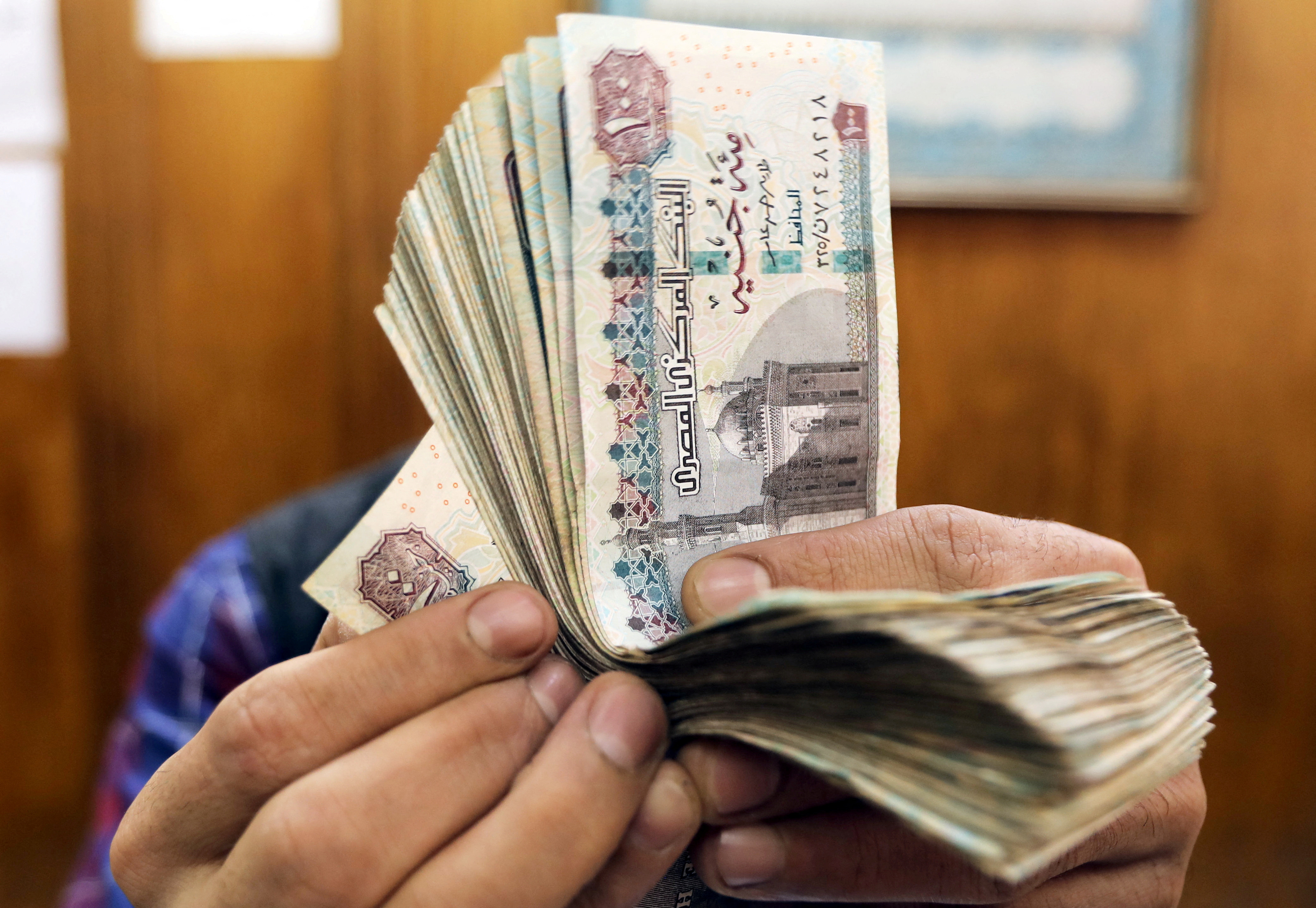 An employee counts Egyptian pounds at a foreign exchange office in central Cairo.