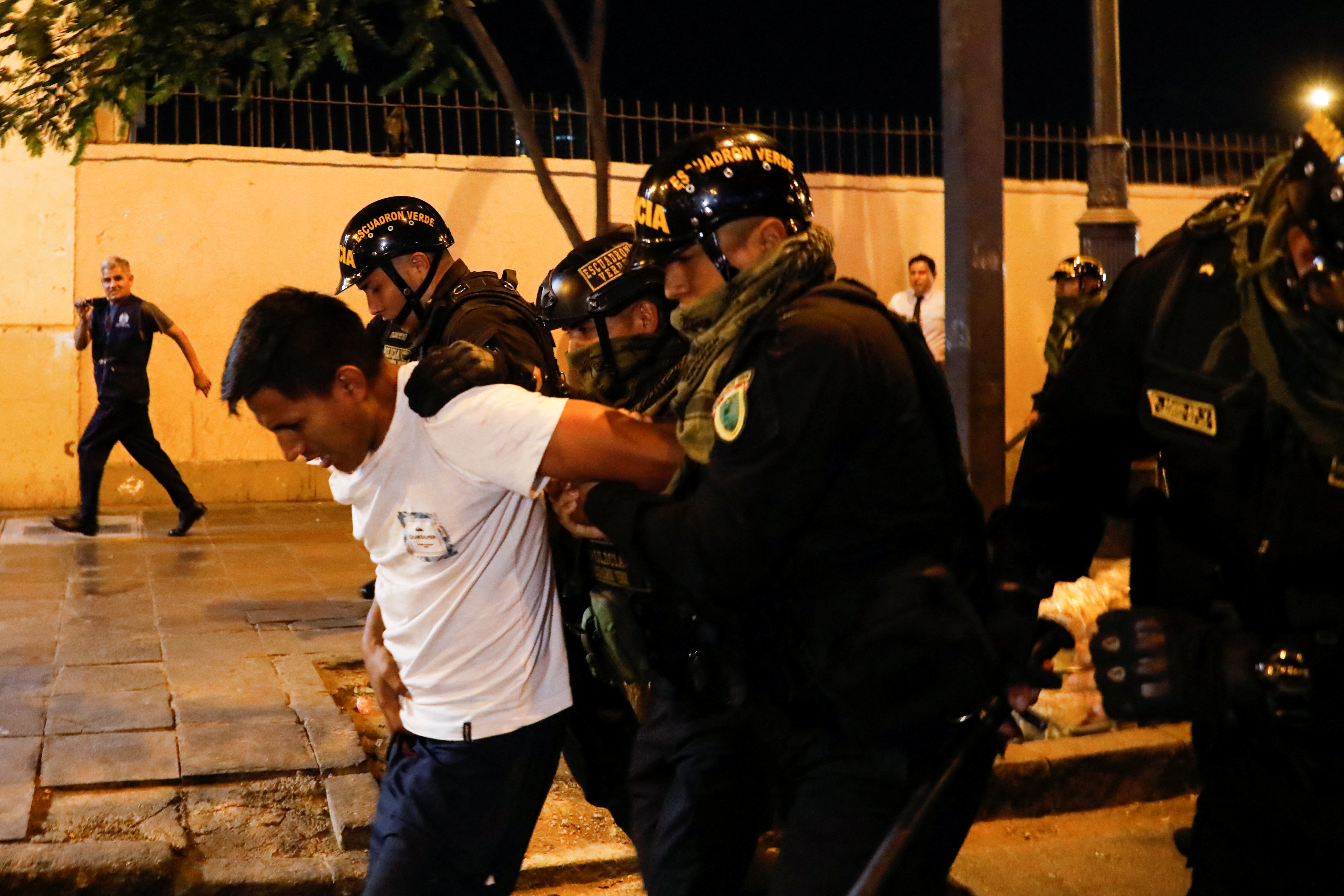 Security forces detain a demonstrator during a protest to demand the dissolution of Congress and democratic elections, rejecting Dina Boluarte as Peru's president, after the ouster of leftist President Pedro Castillo, in Lima, Peru January 12, 2023.