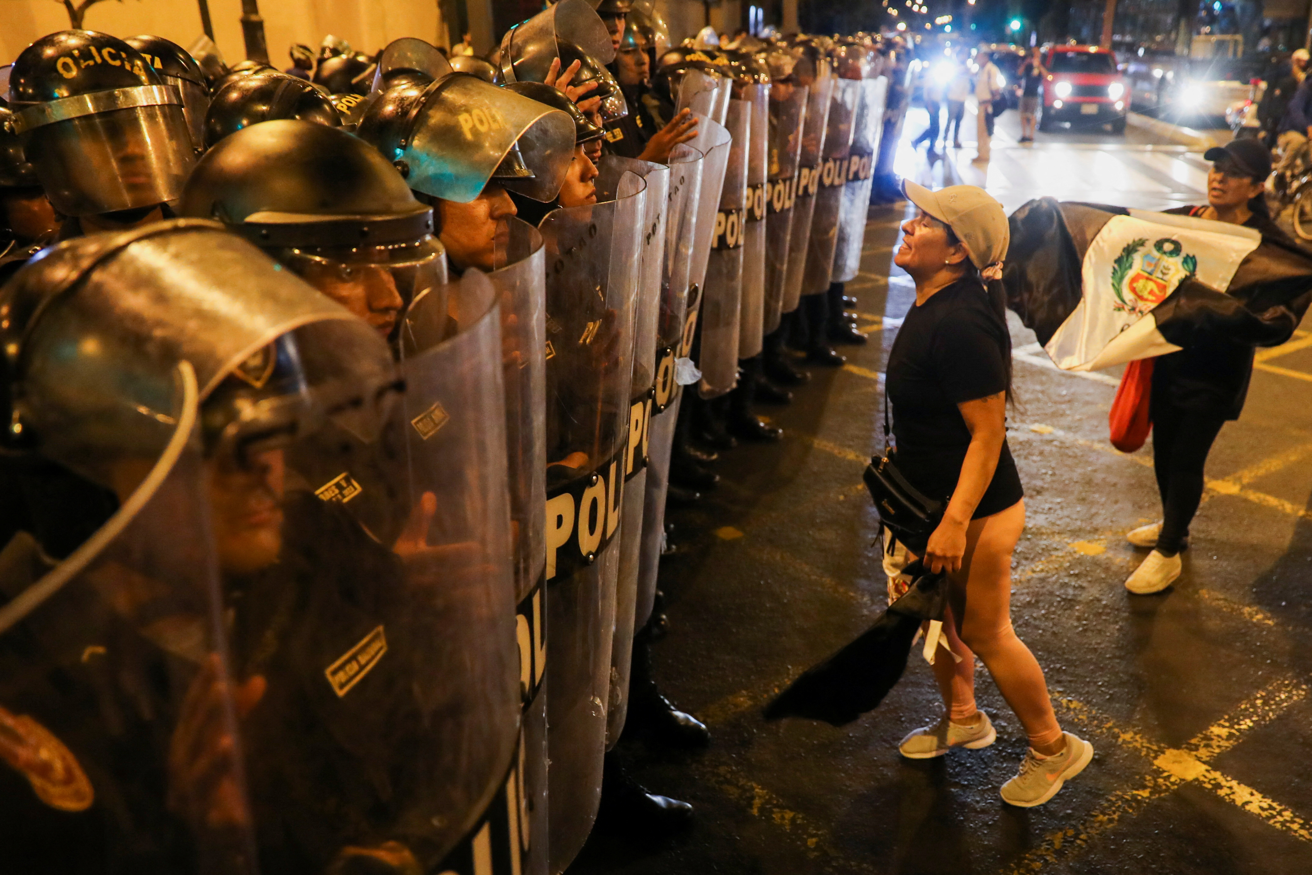 A demonstrator reacts before security forces as people protest demanding the dissolution of Congress and democratic elections, in rejection of Dina Boluarte as Peru's president, after the ouster of leftist President Pedro Castillo, in Lima, Peru January 12, 2023. REUTERS/Sebastian Castaneda