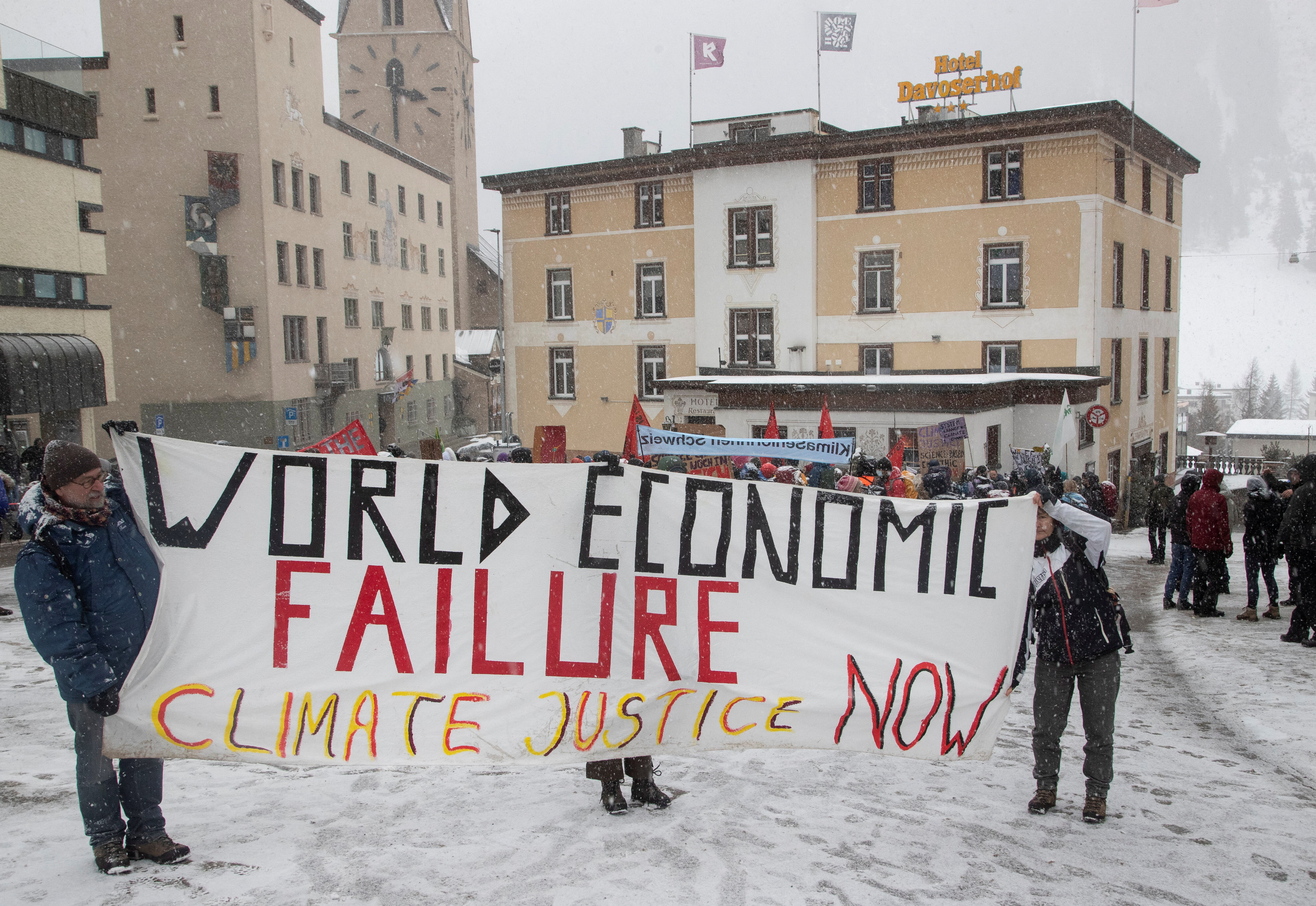 Climate activists display a banner during a protest ahead of the World Economic Forum (WEF) 2023 in the Alpine resort of Davos, Switzerland, January 15, 2023. REUTERS/Arnd Wiegmann