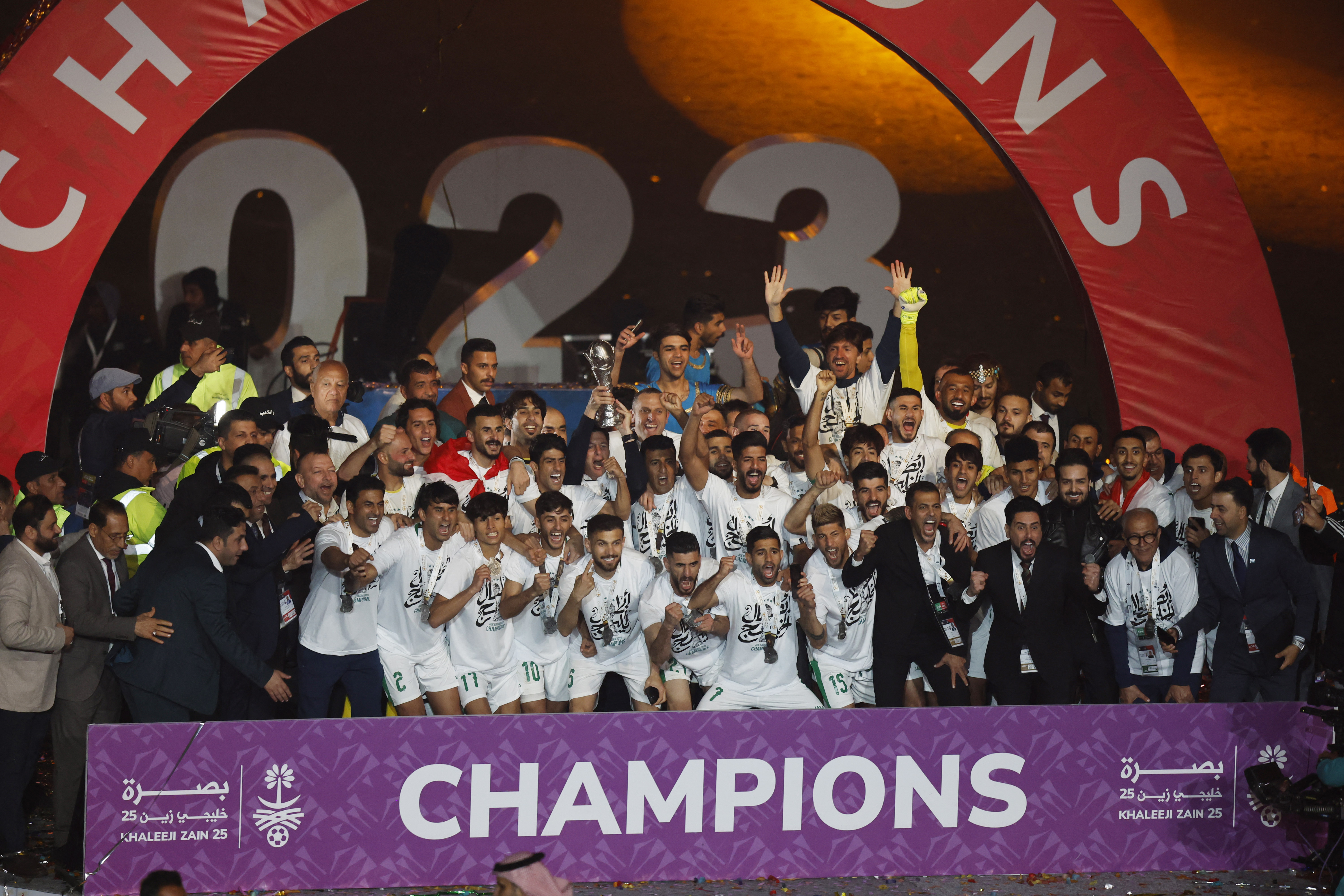 Iraq players celebrate with the trophy after defeating Oman 3-2 in Arabian Gulf Cup
