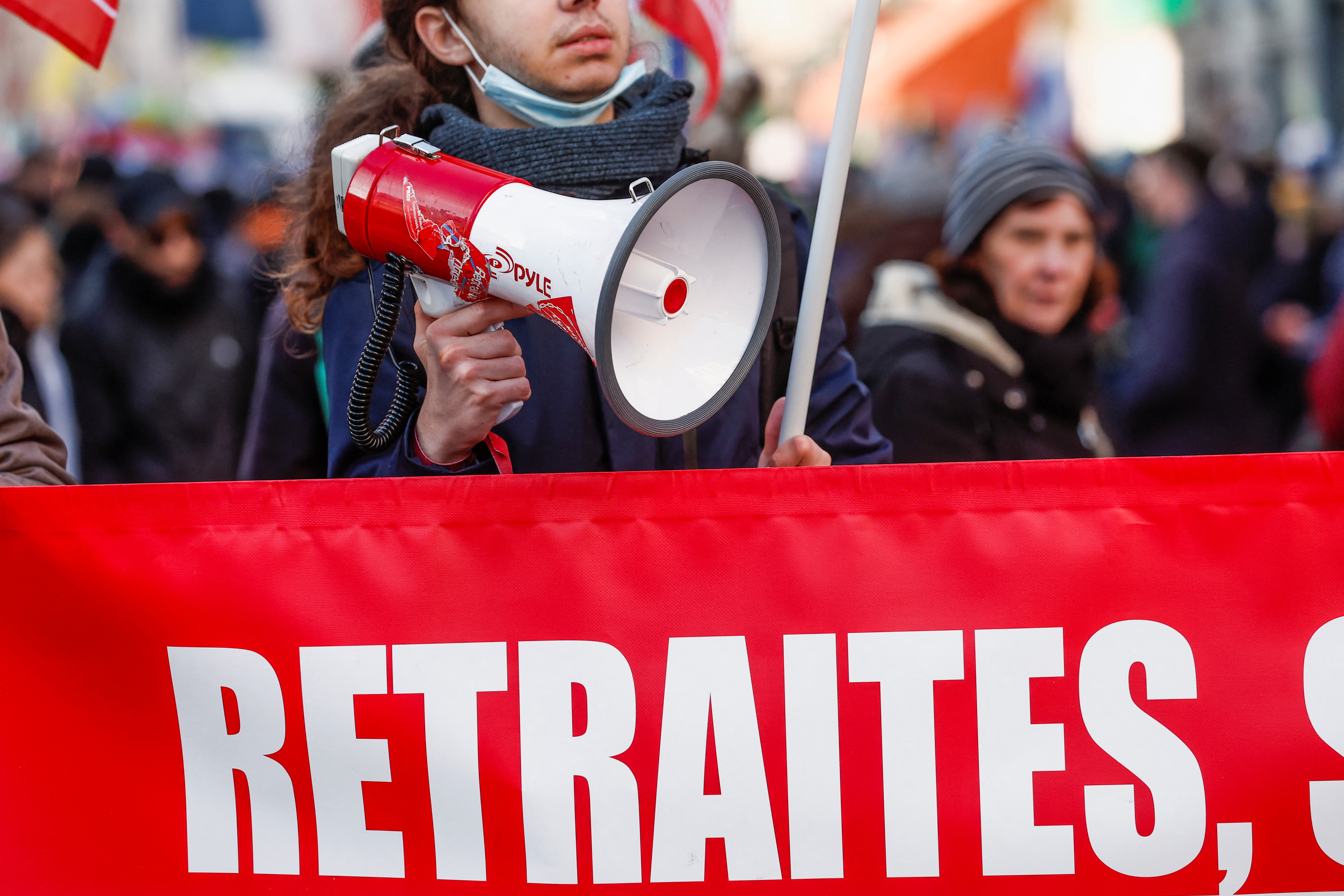 A demonstrator holds a speaker during a rally, called by left-wing La France Insoumise (LFI) party and Youth organizations, against the French government's pension reform plan in Paris, France, January 21, 2023.