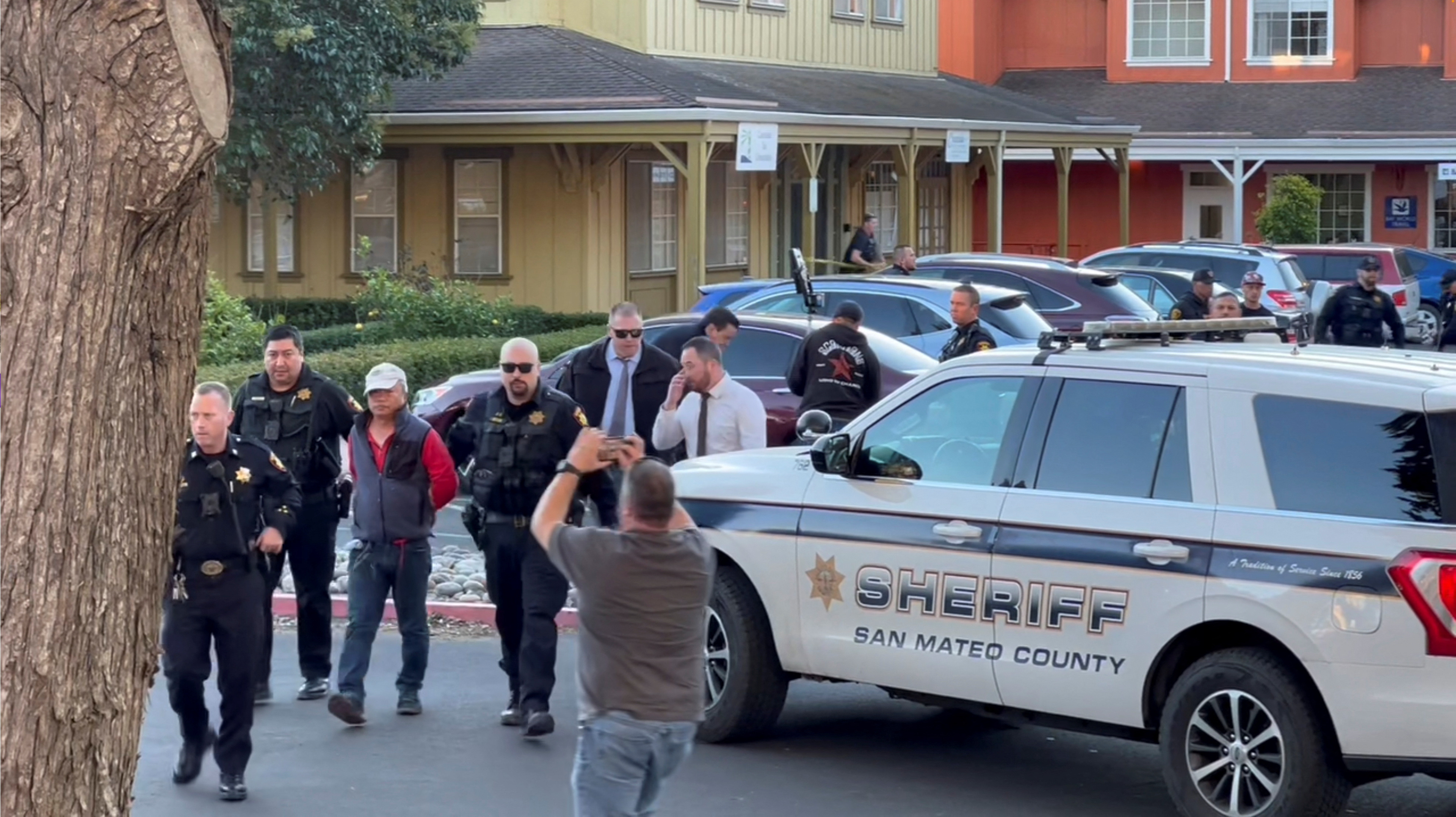Police officers detain a man, believed by law enforcement to be the Half Moon Bay mass shooting suspect, in Half Moon Bay, California, U.S., January 23, 2023, in this screengrab taken from a social media video