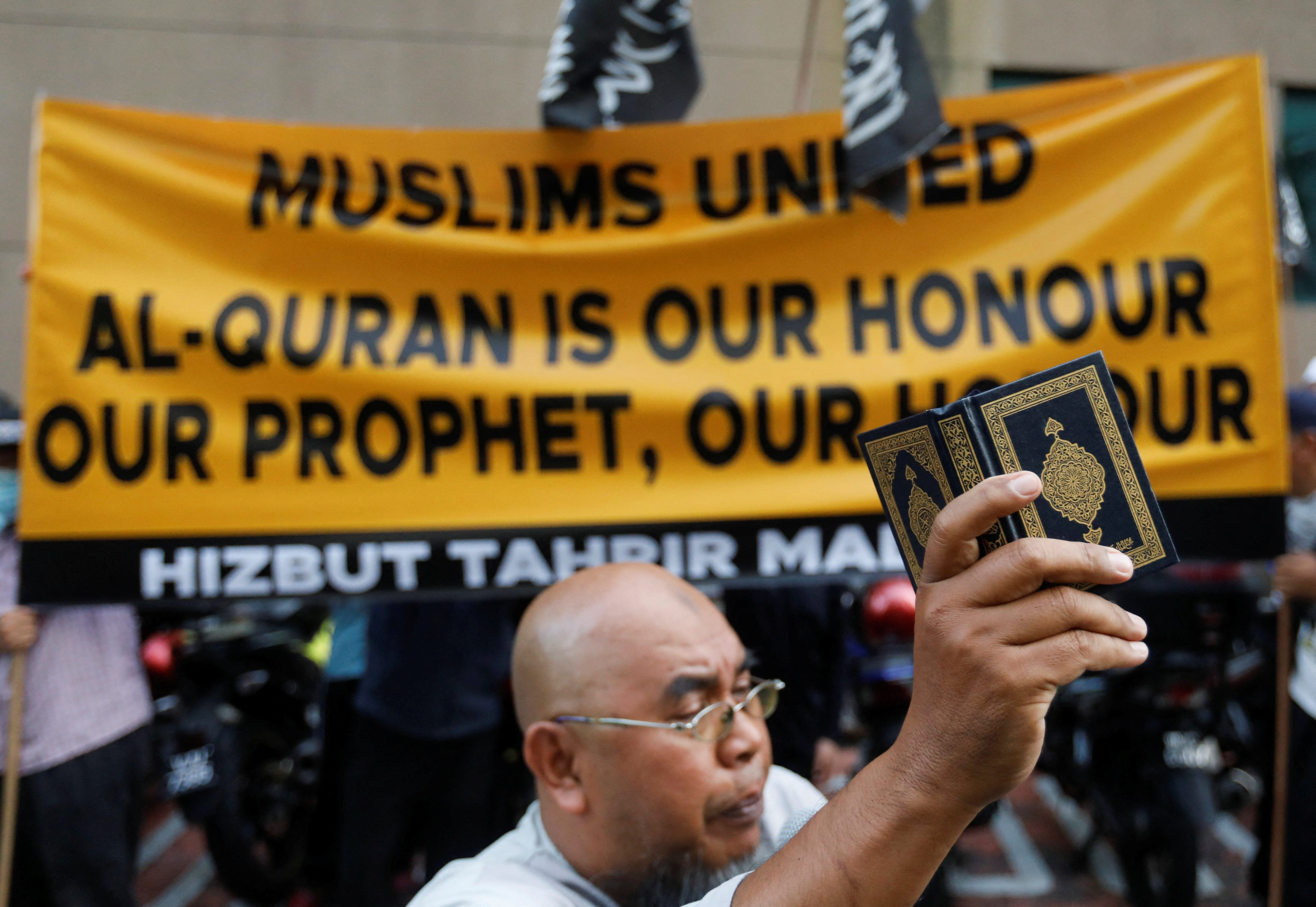 A man holds copy of the Koran during a protest in front of Swedish embassy after Rasmus Paludan, leader of Danish far-right political party Hard Line burned a copy of the Koran near the Turkish Embassy in Stockholm, in Kuala Lumpur, Malaysia January 27, 2023. REUTERS/Hasnoor Hussain