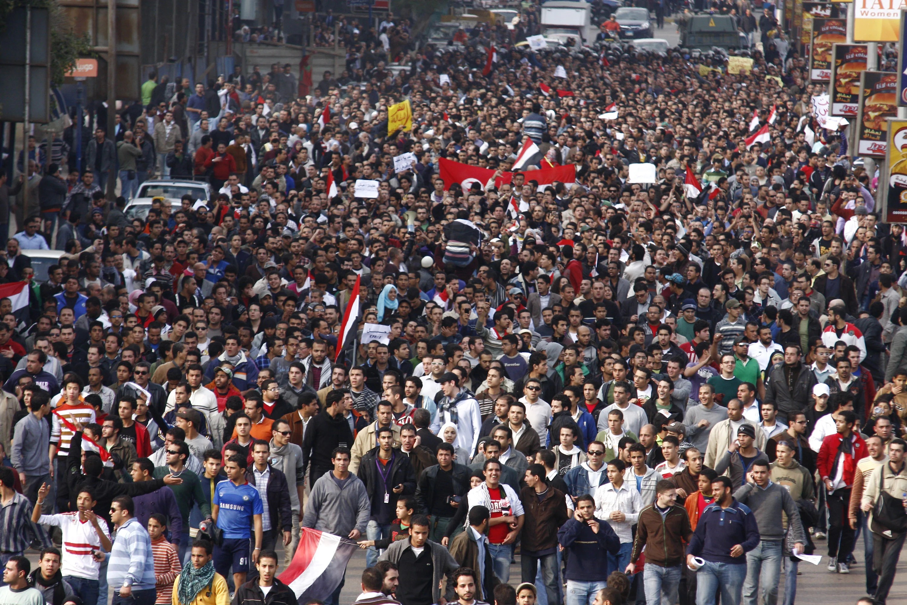 A crowd of demonstrators walks through Cairo on January 25, 2011, to demand the end of President Hosni Mubarak's nearly 30 years in power. [AP]