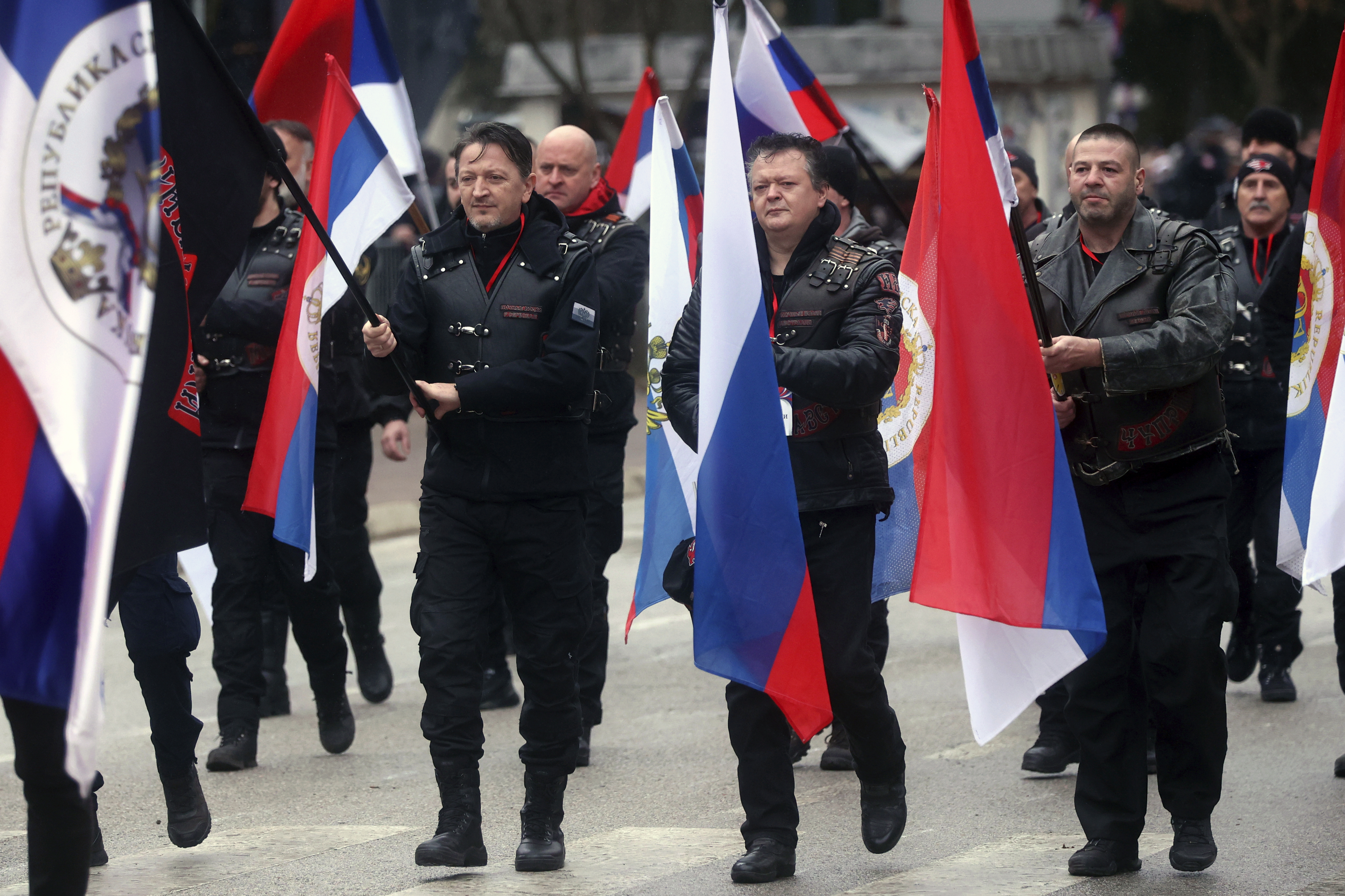 Local members of Russian Night Wolves Motorcycle Club march during a parade marking the 31st anniversary of the Republic of Srpska in Istocno Sarajevo, Bosnia, Monday, Jan. 9, 2023. Thousands of flag-waving people gathered on the outskirts of Sarajevo to celebrate an outlawed holiday associated with the country's brutal inter-ethnic war in the 1990s and attend a military-style parade organized for the occasion and used by Bosnian Serb separatist leader, Milorad Dodik, to showcase his allegiance to Russia. (AP Photo/Armin Durgut)