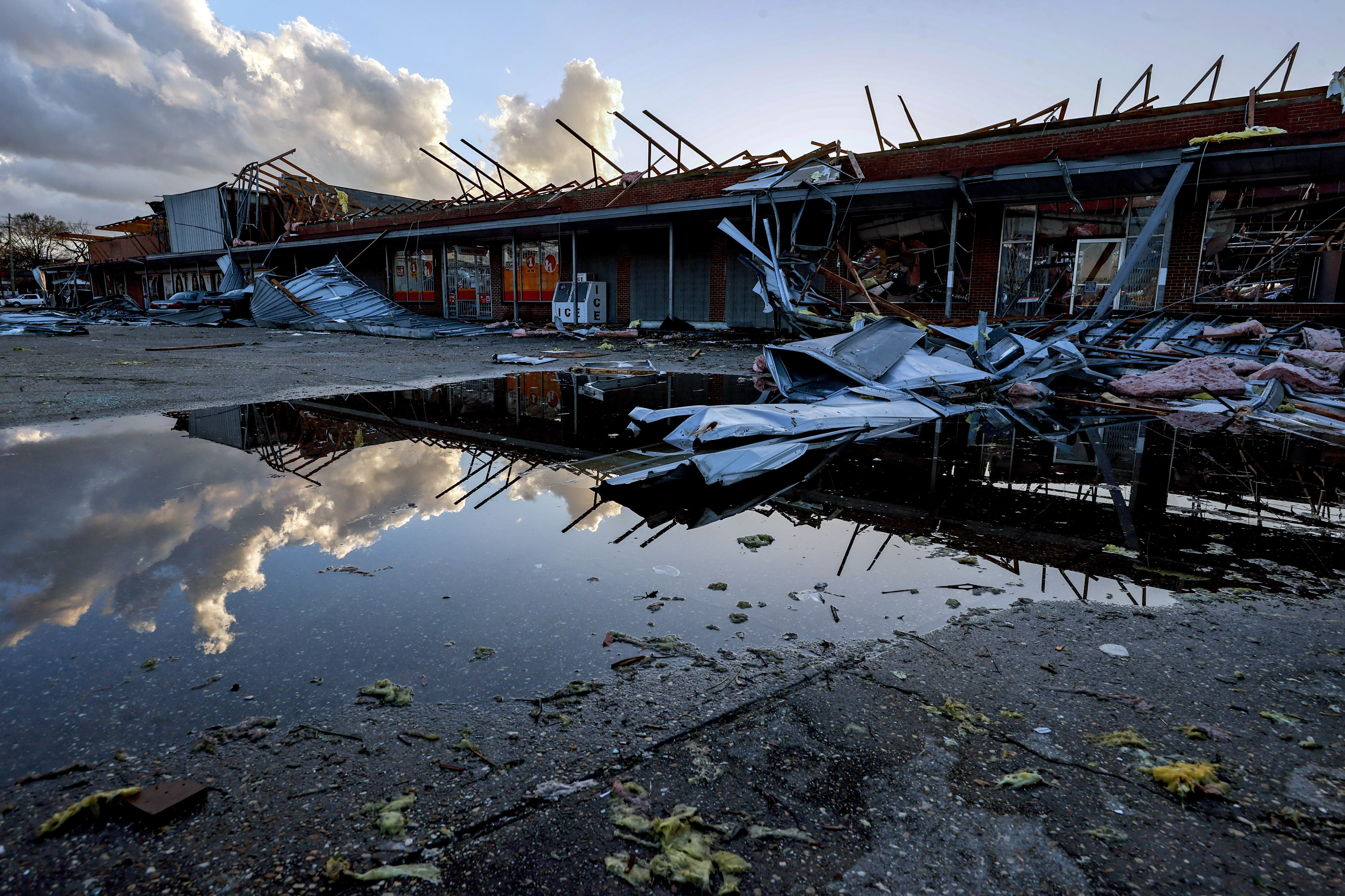 The roof of a local businesses is strewn about after a tornado