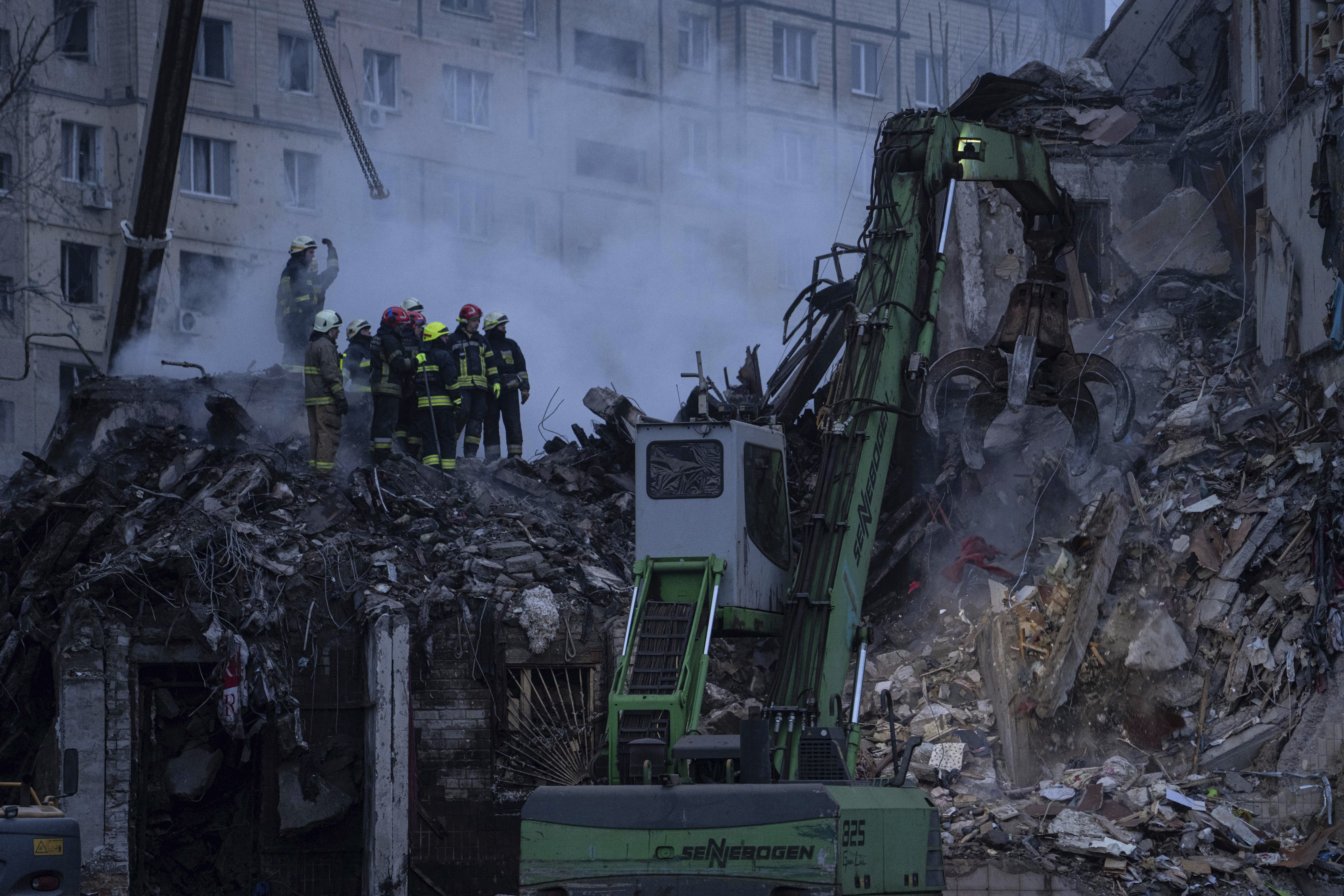 Rescue workers at a destroyed building 