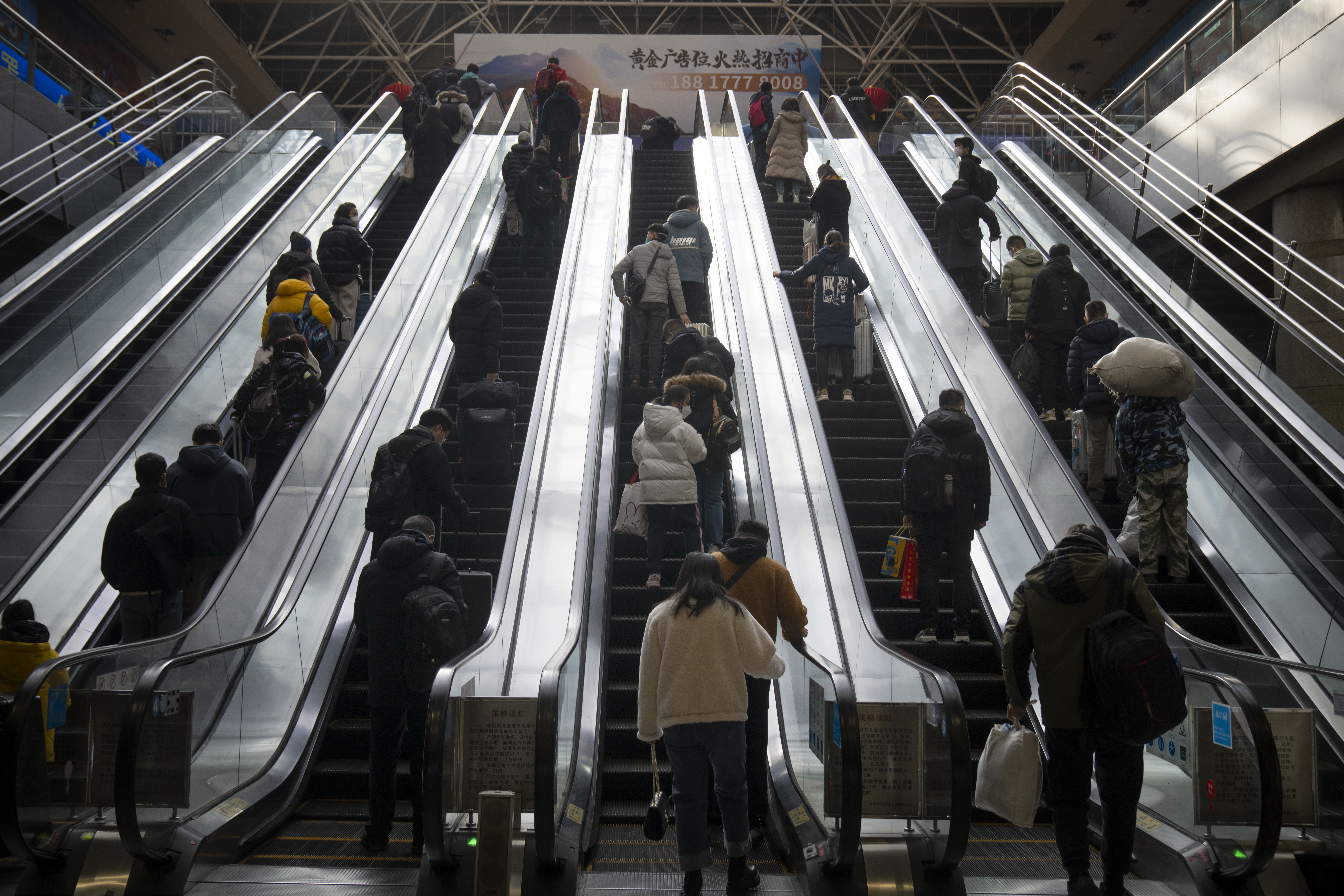 View from bottom of escalators. There are four going up.