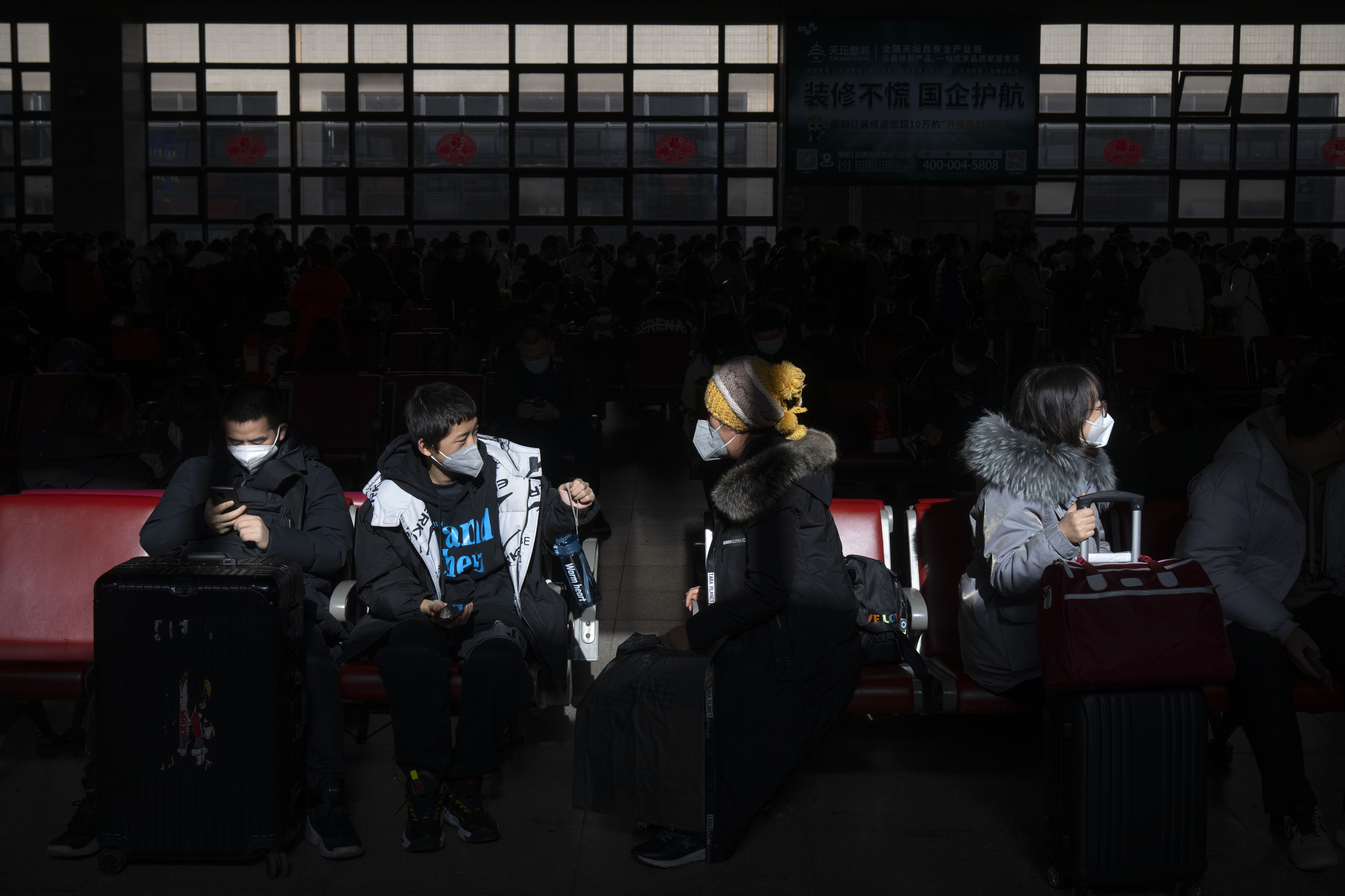 Travelers sit in a waiting room at Beijing West Railway Station in Beijing
