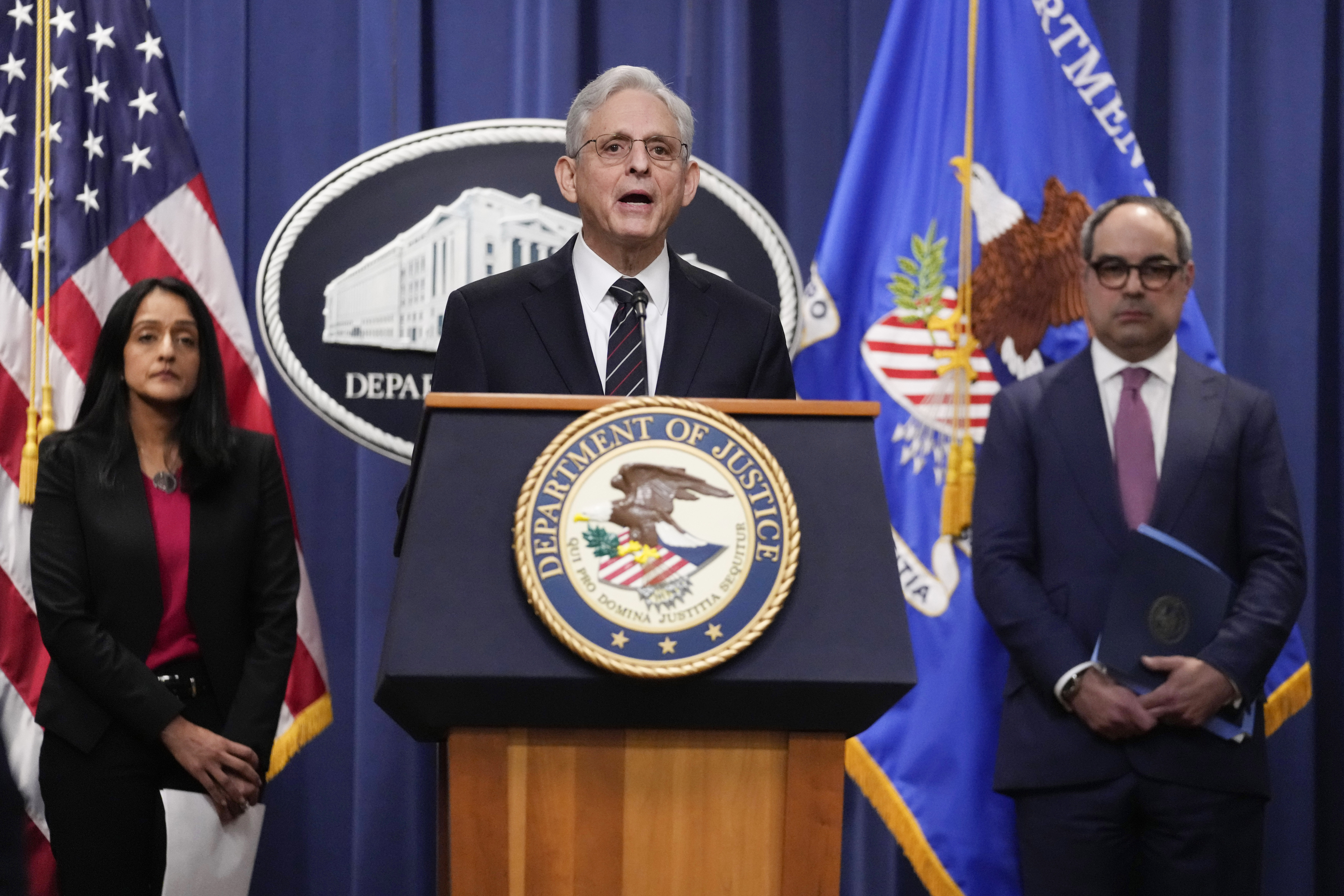 Attorney General Merrick Garland, joined by Associate Attorney General Vanita Gupta and Assistant Attorney General Jonathan Kanter of the Justice Department's Antitrust Division, speaks from a lectern at the Department of Justice in Washington, DC, on Tuesday.