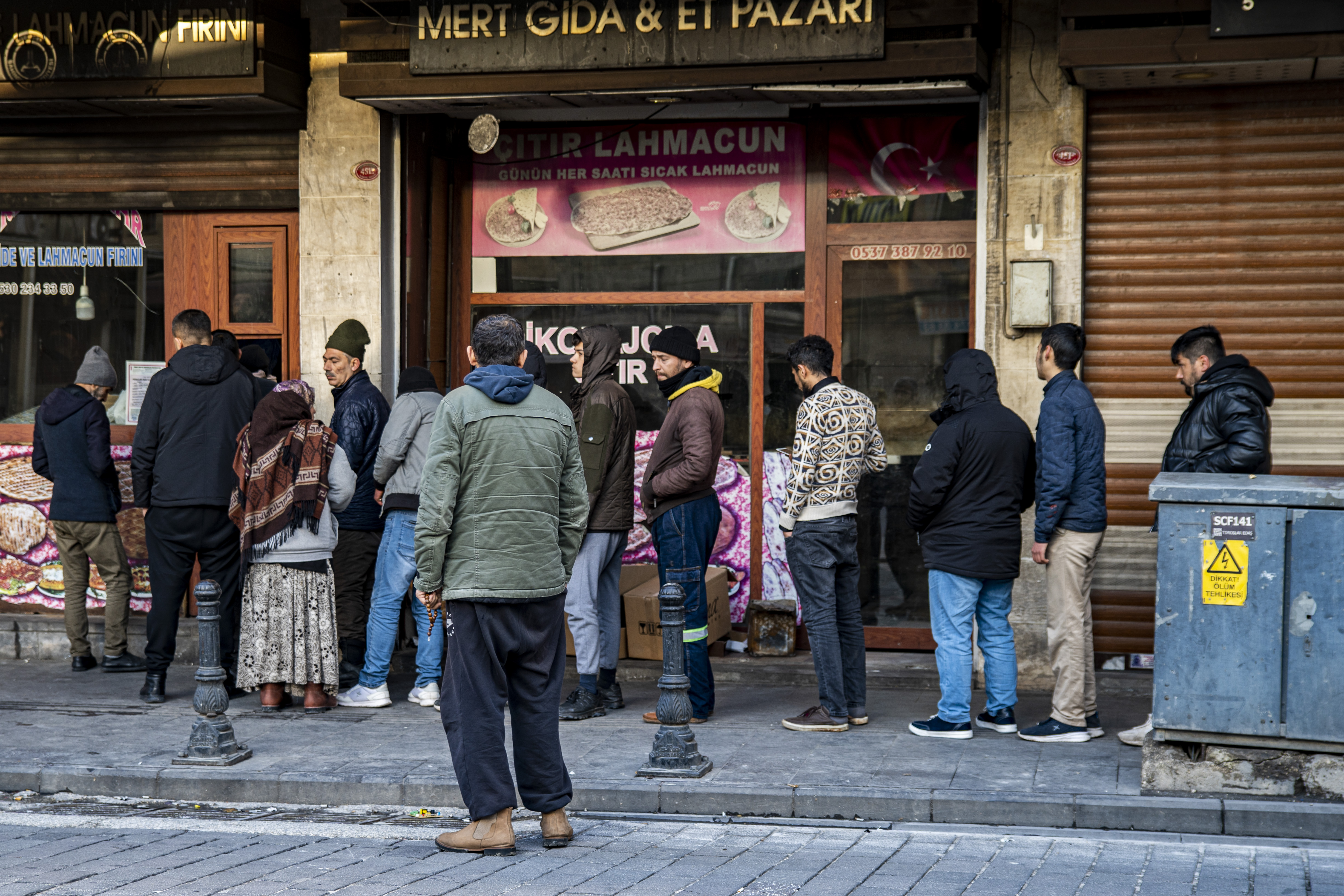People line up behind a bakery