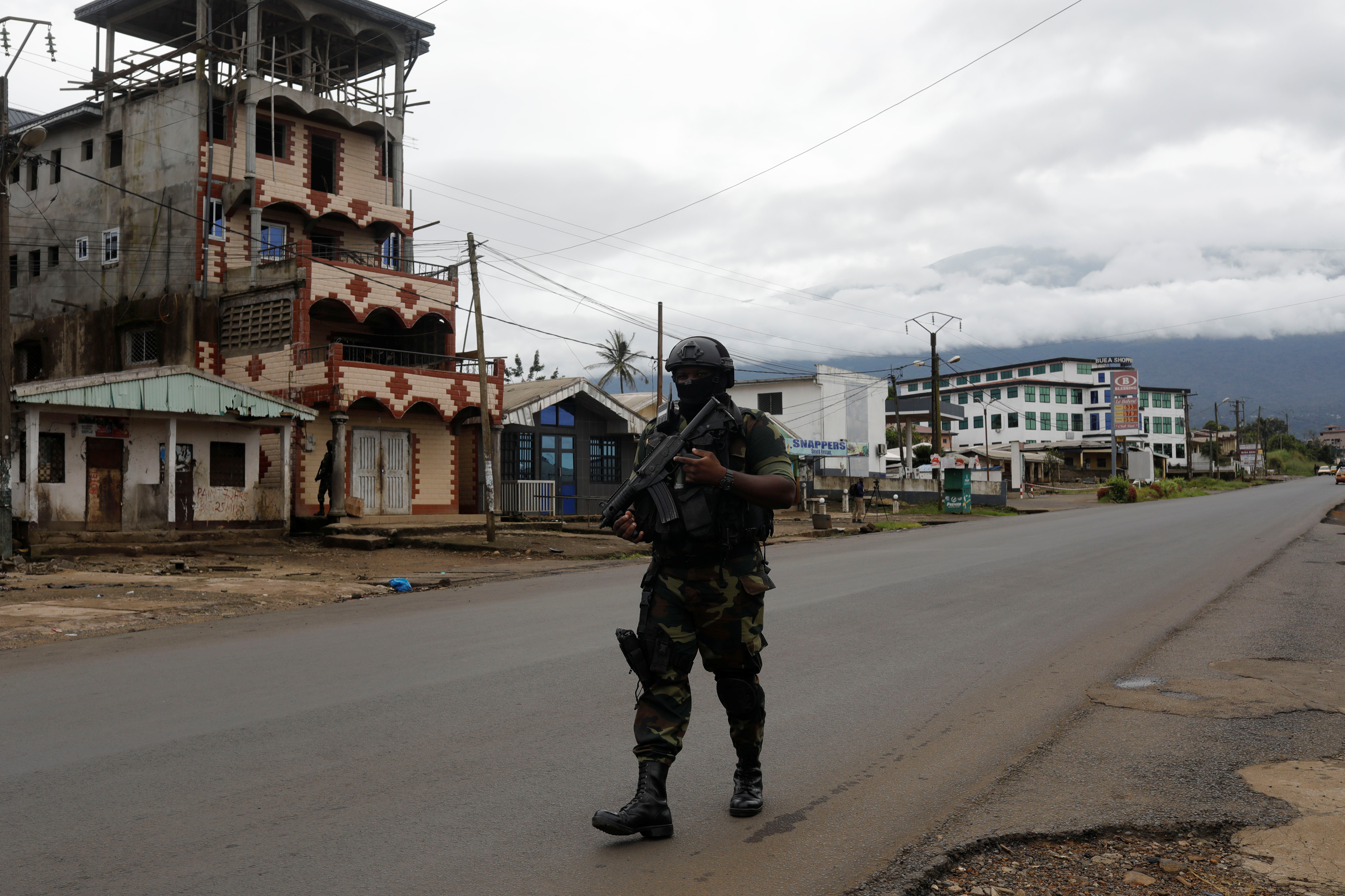 A soldier walks on a road in Cameroon