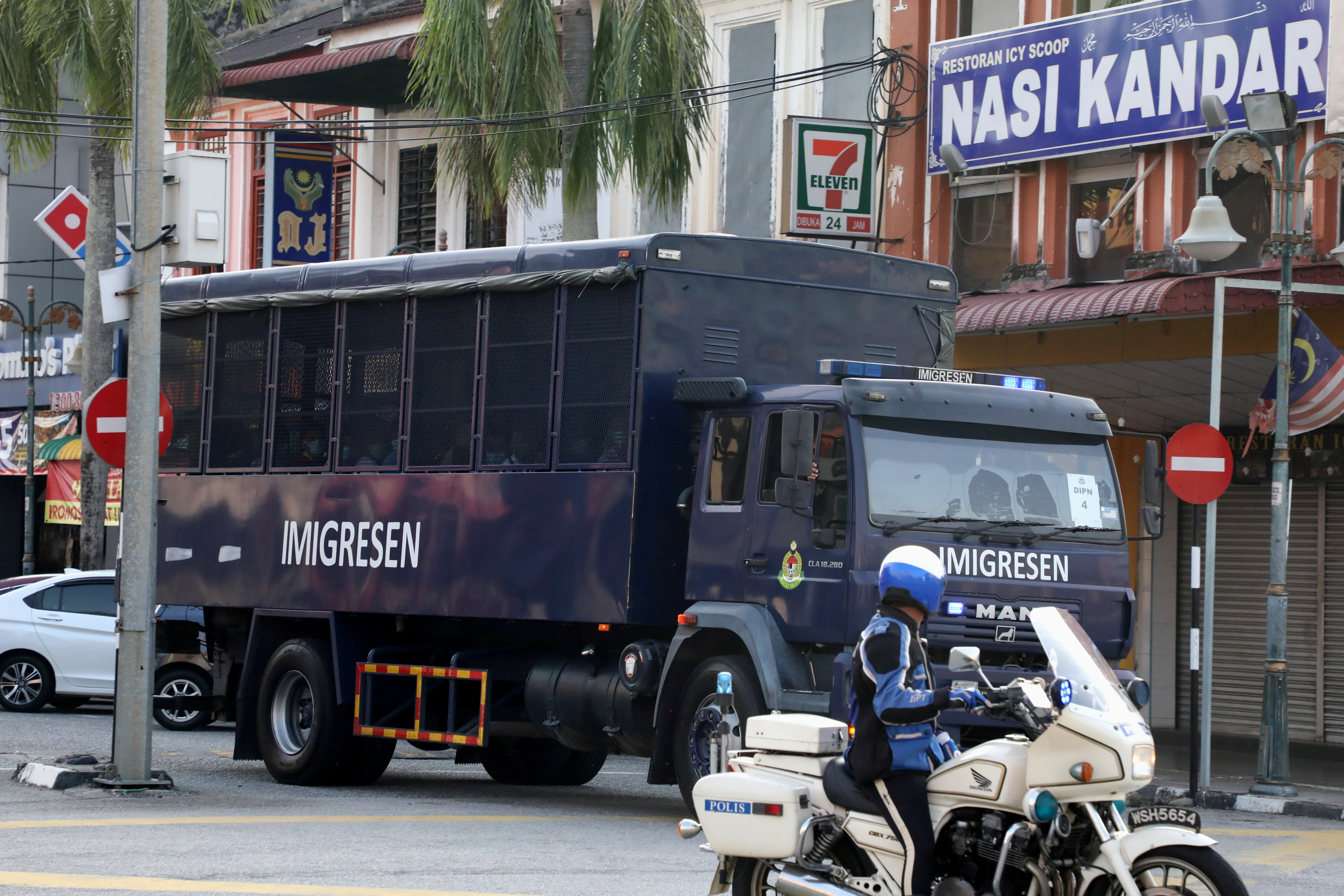 FILE PHOTO: An immigration truck carrying Myanmar migrants to be deported from Malaysia is seen in Lumut, Malaysia February 23, 2021. REUTERS/Lim Huey Teng/File Photo