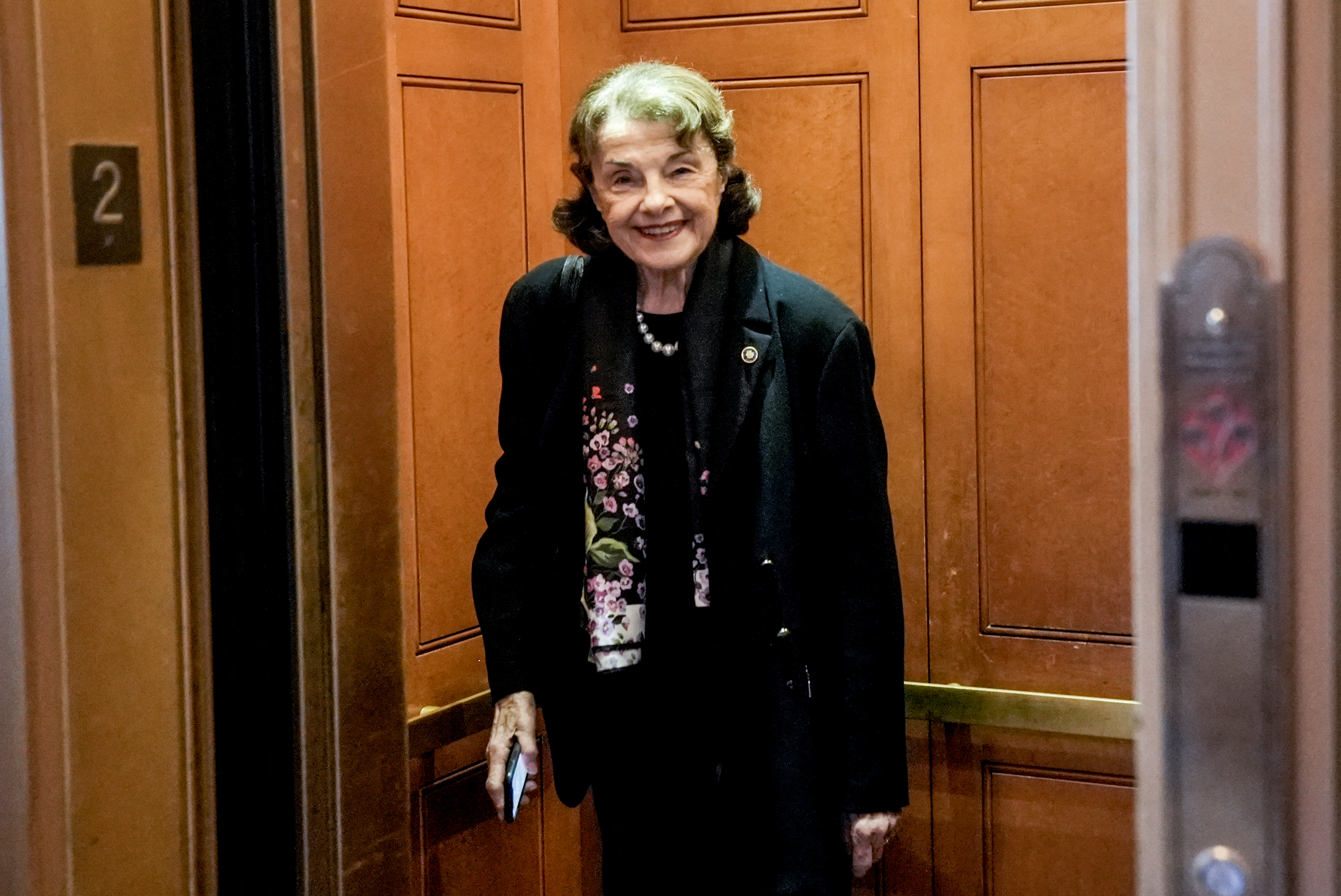 US Senator Dianne Feinstein enters an elevator.
