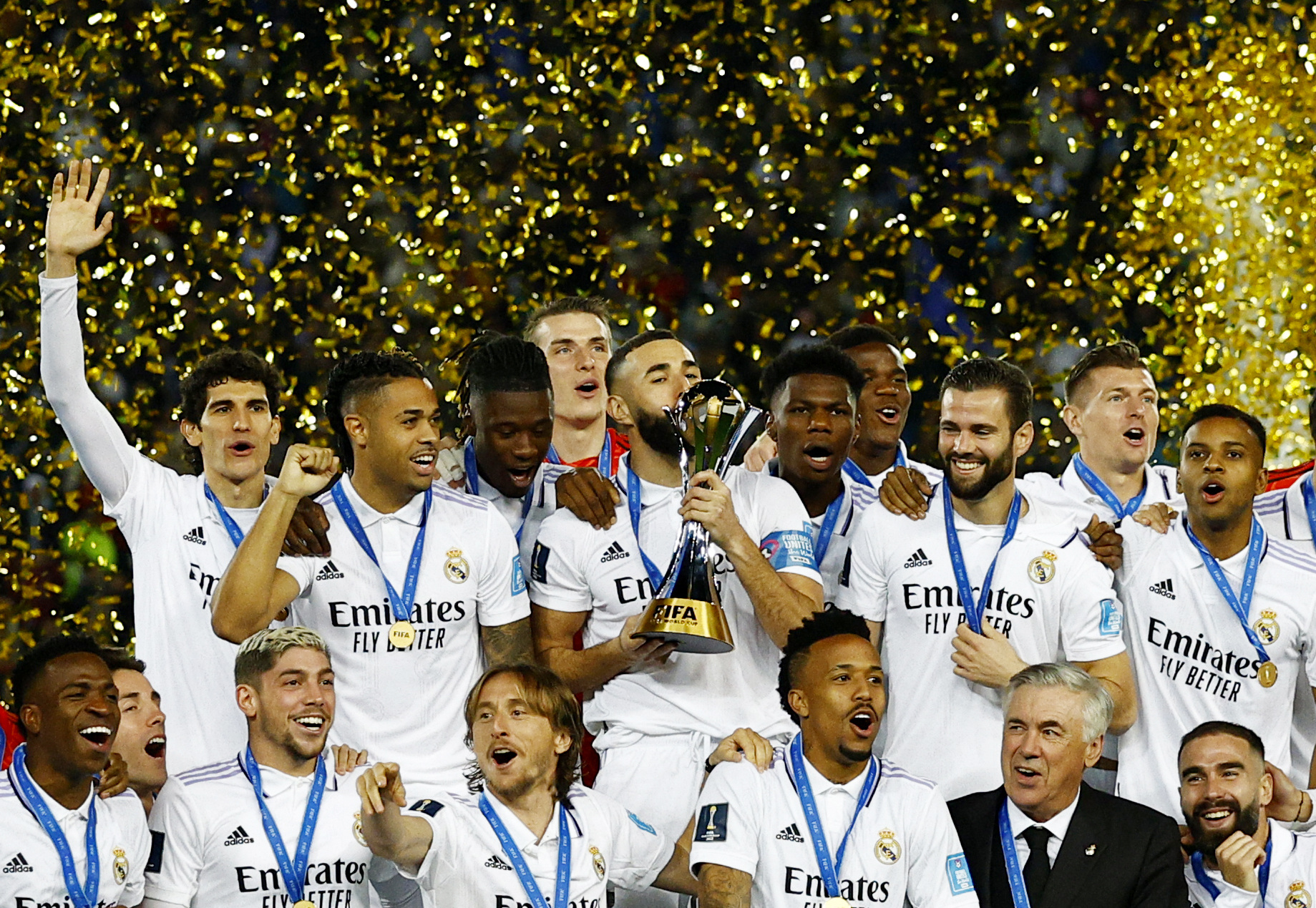 Real Madrid's Karim Benzema kisses the trophy and celebrates with teammates