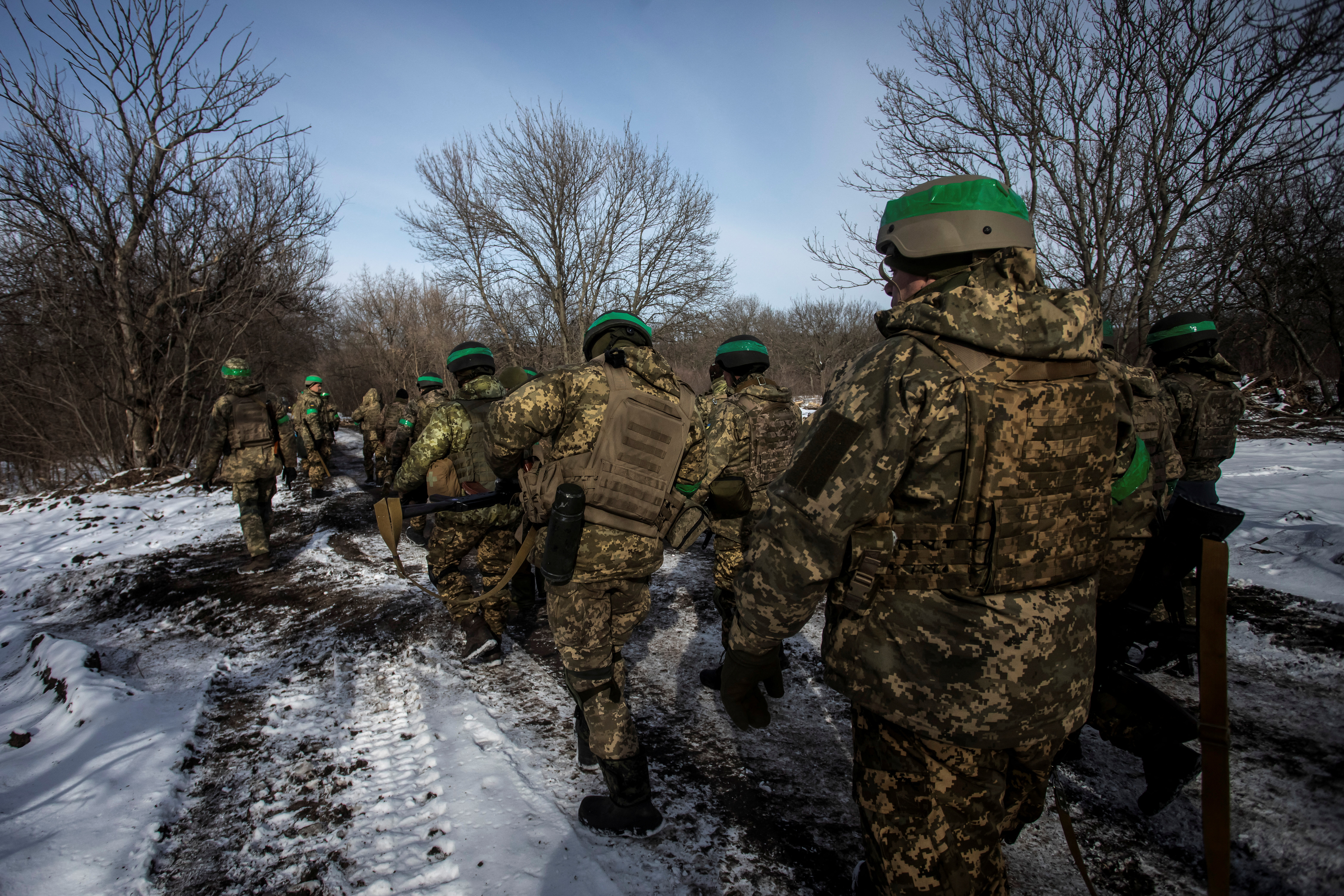 Ukrainian servicemen walk on a road outside the frontline town of Bakhmut.