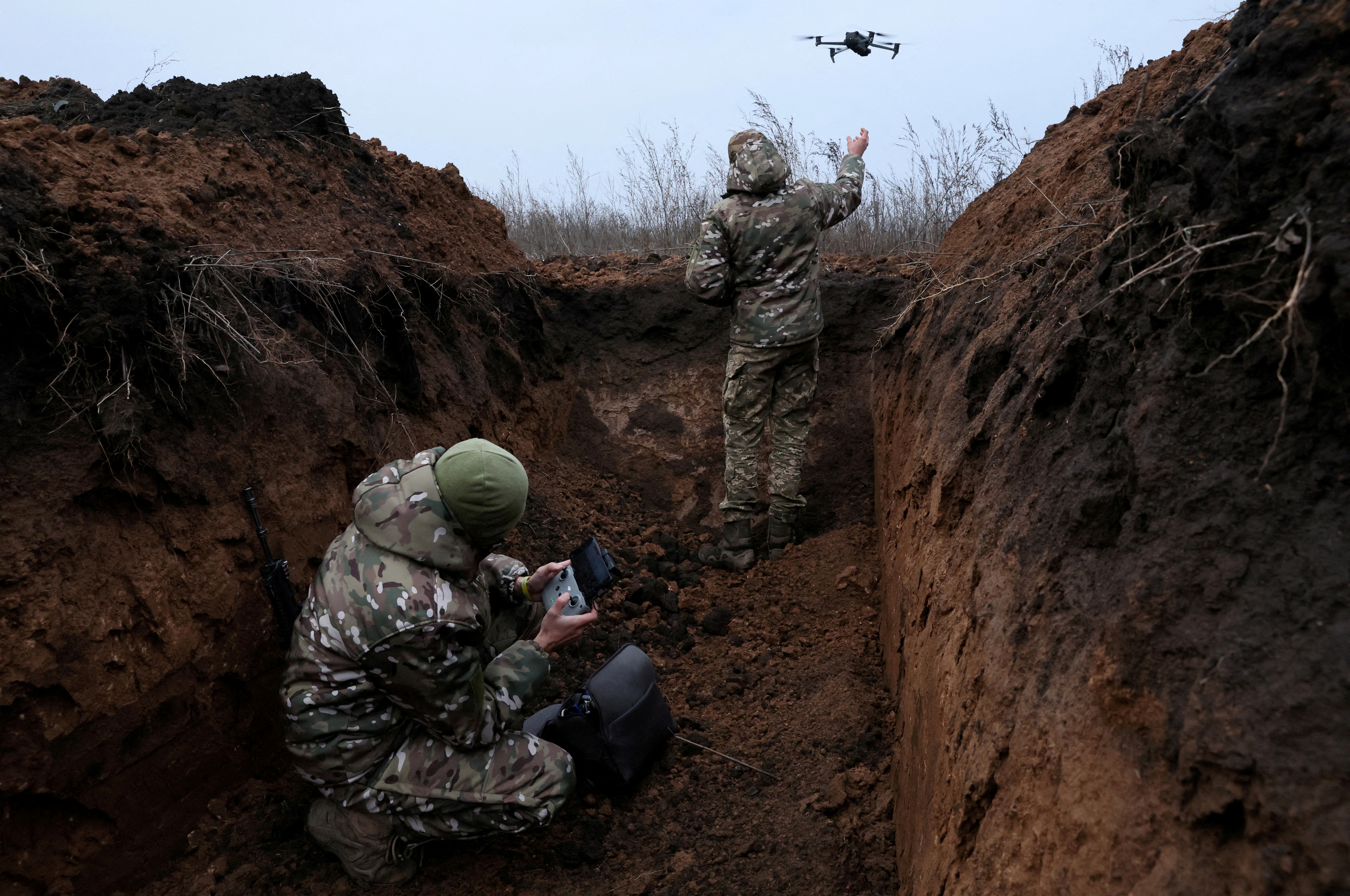FILE PHOTO: Two soldiers with the 58th Independent Motorized Infantry Brigade of the Ukrainian Army who wanted to be identified as "Ghost", 24, and "Soap", 30, release their drone for a test flight, as Russia's invasion of Ukraine continues, near Bakhmut, Ukraine, November 25, 2022. REUTERS/Leah Millis SEARCH " UKRAINE-CRISIS/ANNIVERSARY-TIMELINE" FOR ALL IMAGES/File Photo
