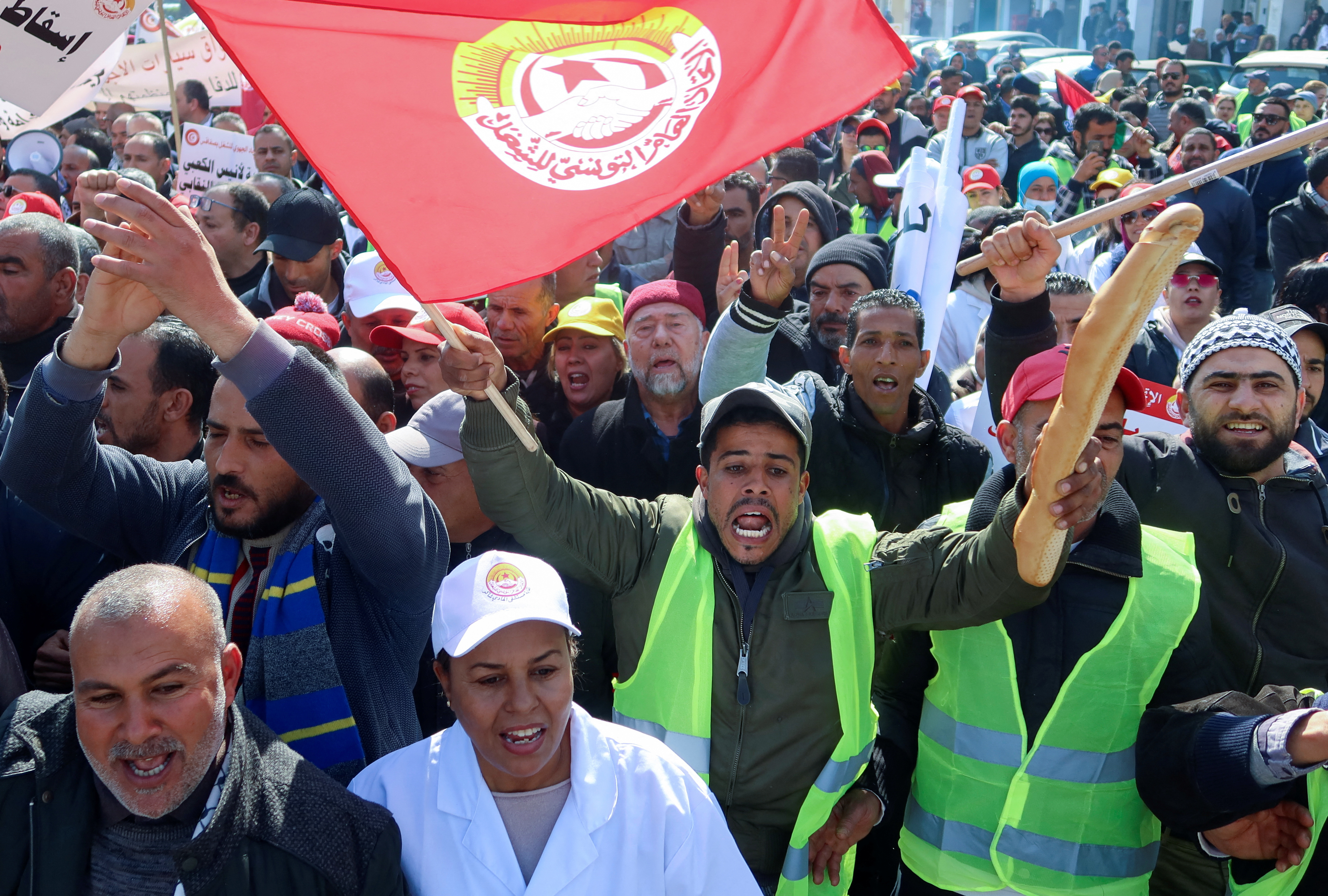 A supporter of the Tunisian General Labour Union (UGTT), carries bread as he shouts slogans during a protest against President Kais Saied's policies, accusing him of trying to stifle basic freedoms including union rights, in Sfax, Tunisia February 18, 2023. REUTERS/Jihed Abidellaoui