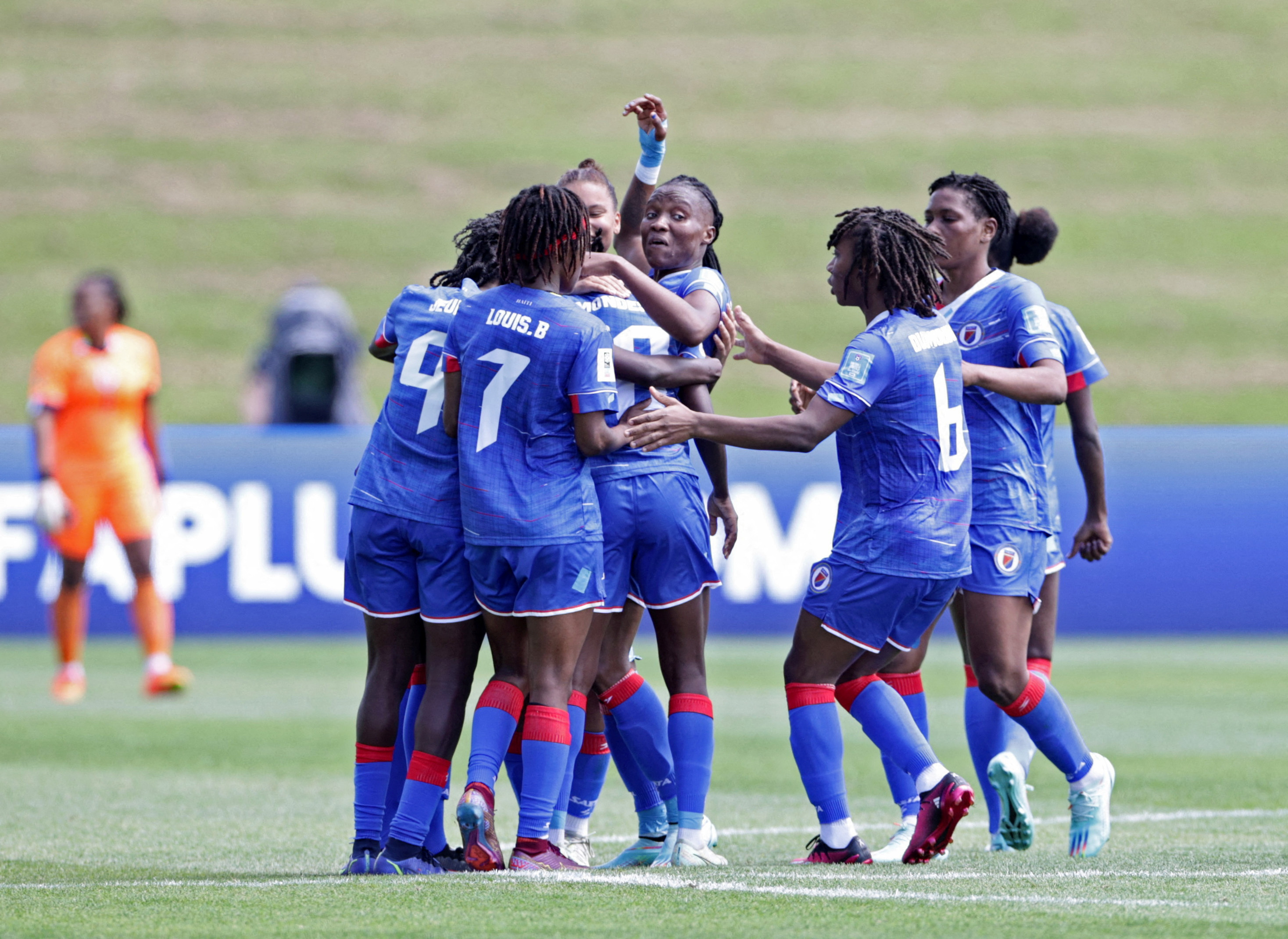 Haiti's Nerilia Mondesir celebrates scoring their second goal with teammates
