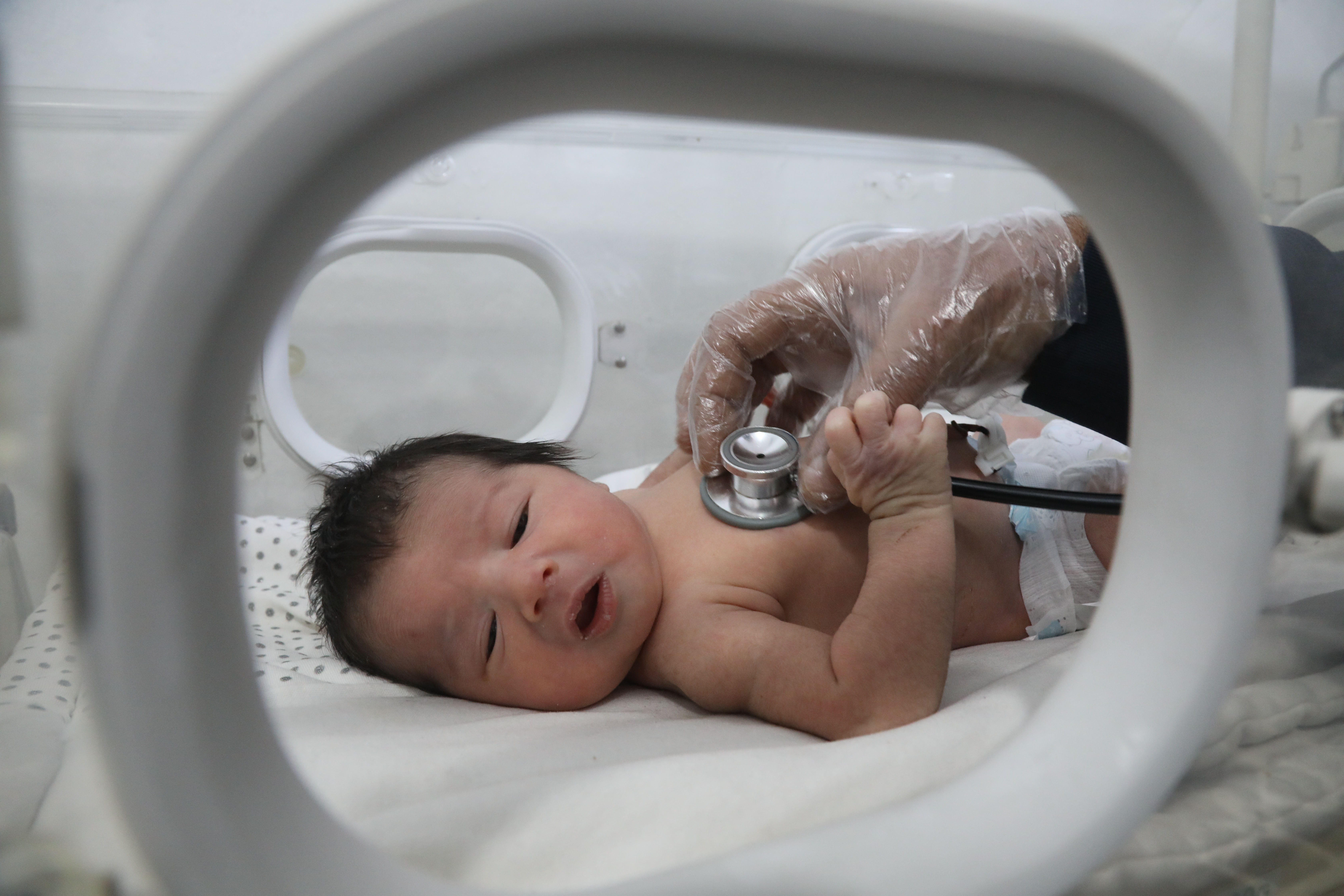Baby Aya being checked with a stethoscope
