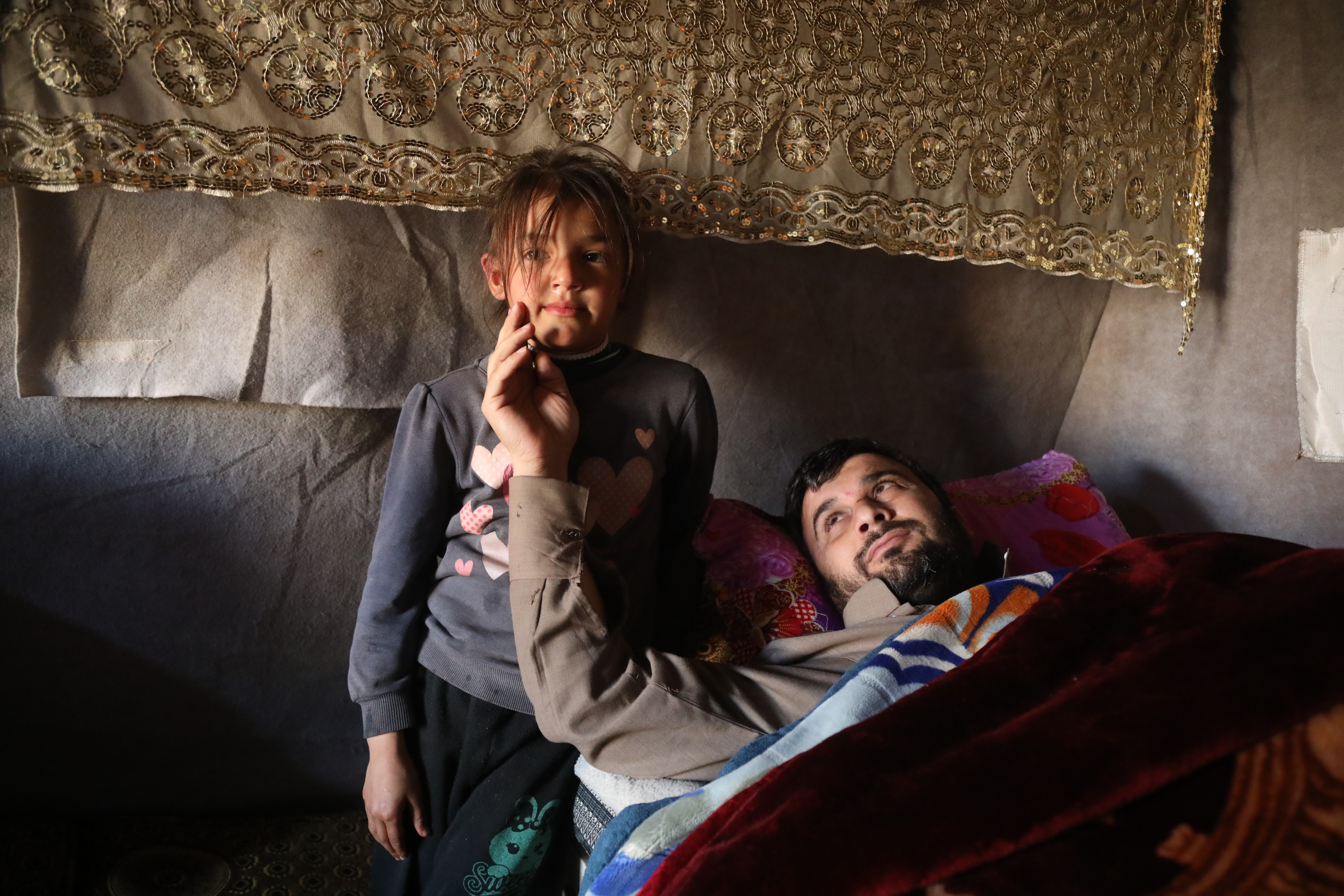 Tariq al-Sayel, who lost 70 relatives, and one of his daughters