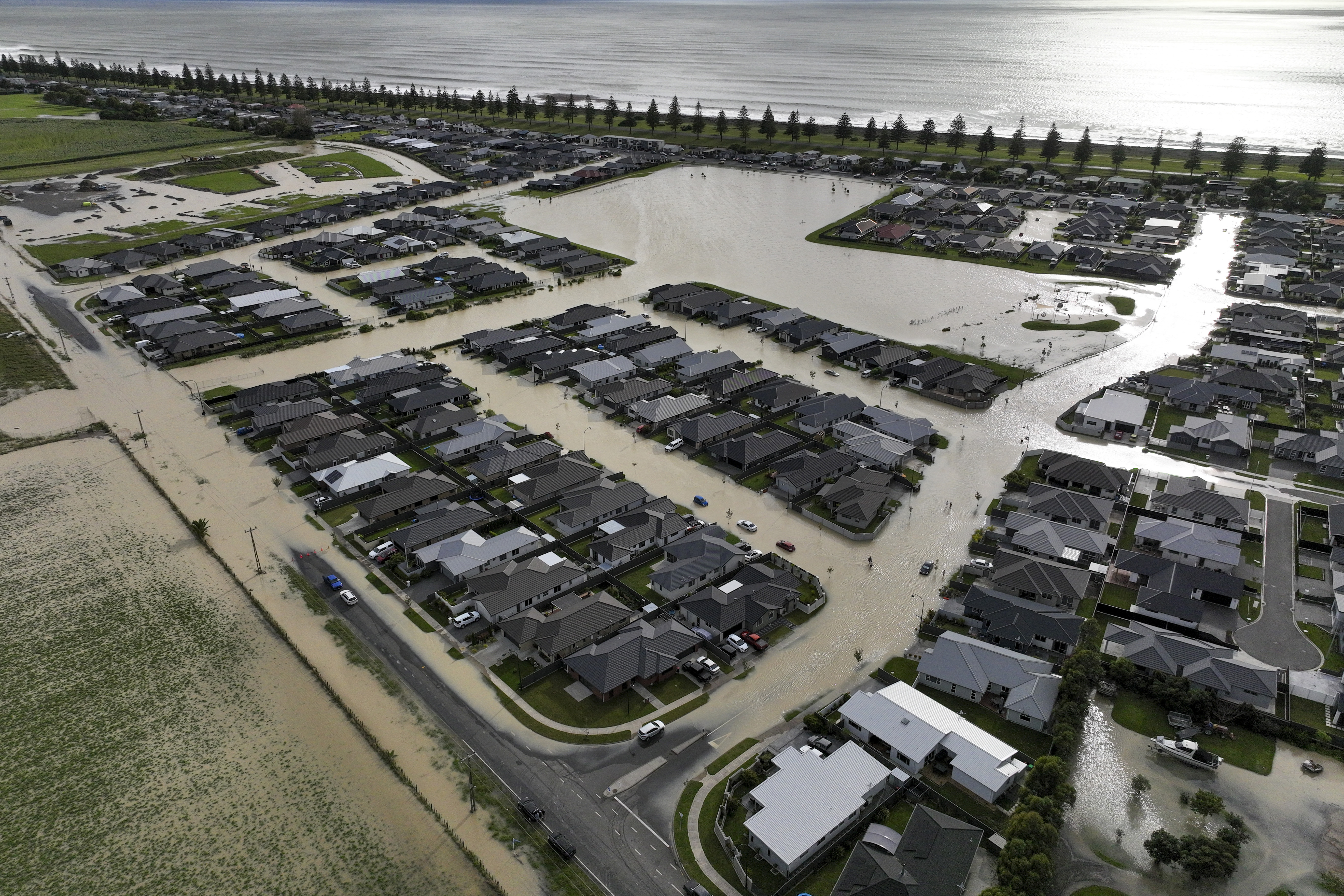 The flooded town of Napier from the air. The streets are in a grid pattern. They are mostly submerged in brown water