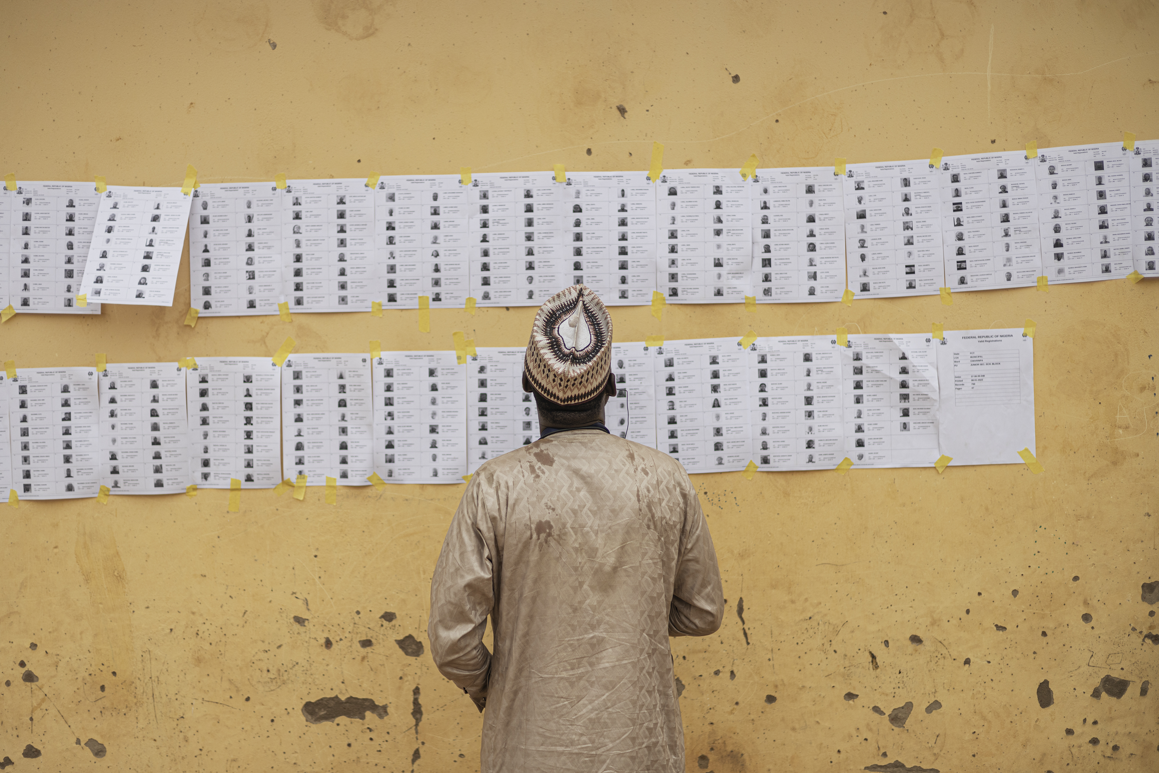 A voter looks for his name