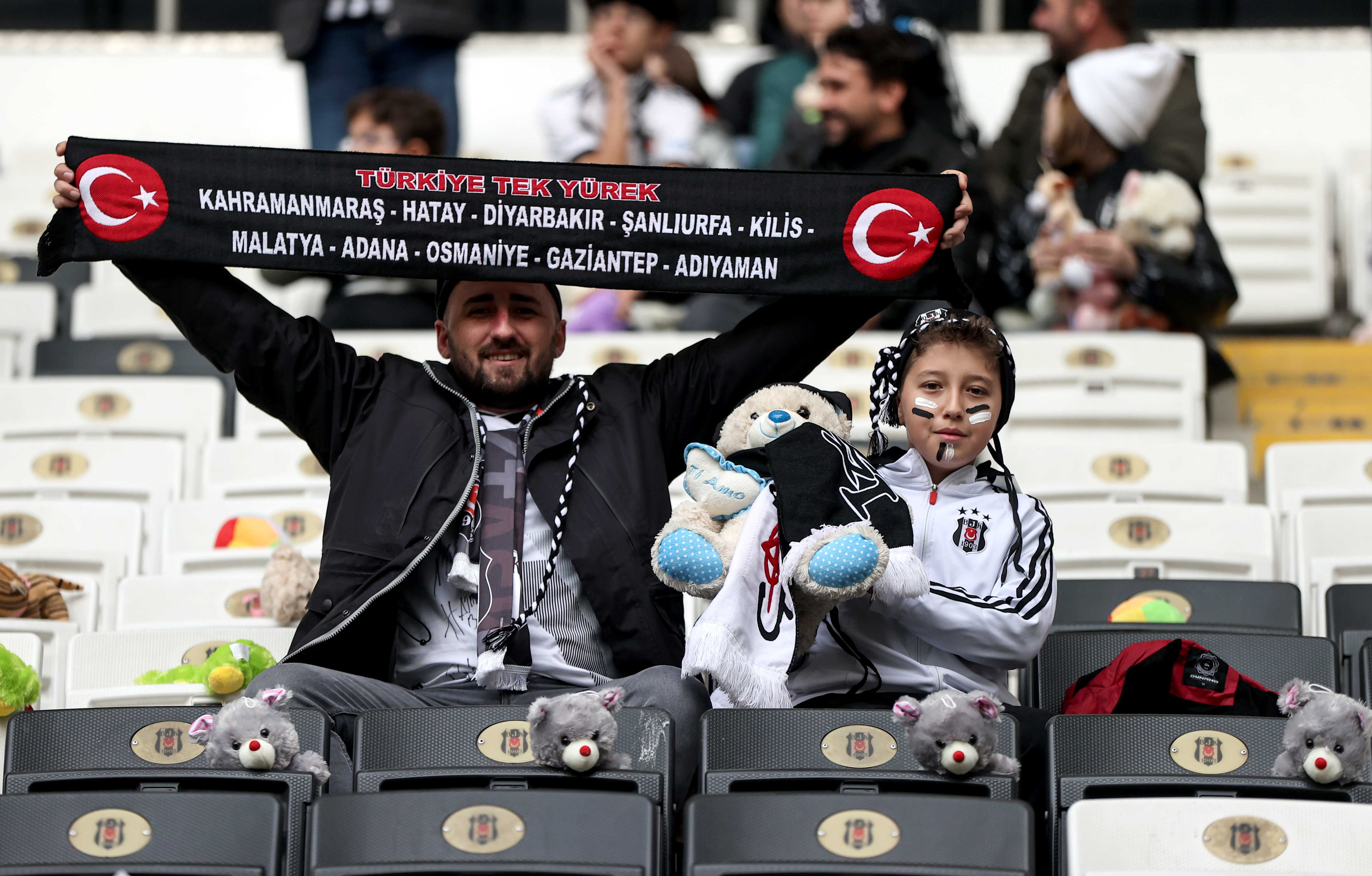 Fans throw toys onto the pitch during the Turkish Super League football match