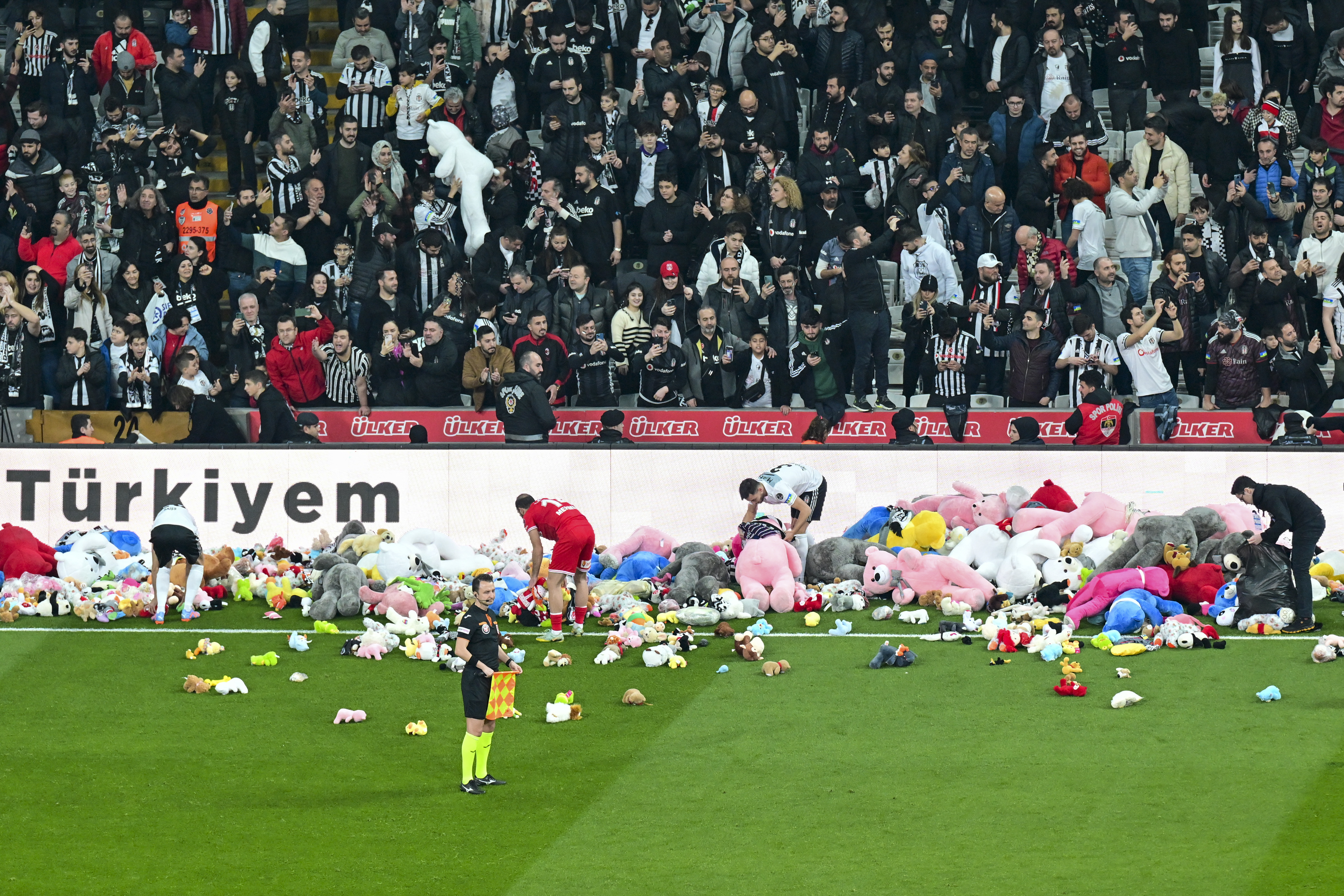 Fans throw toys onto the pitch during the Turkish Super League football match