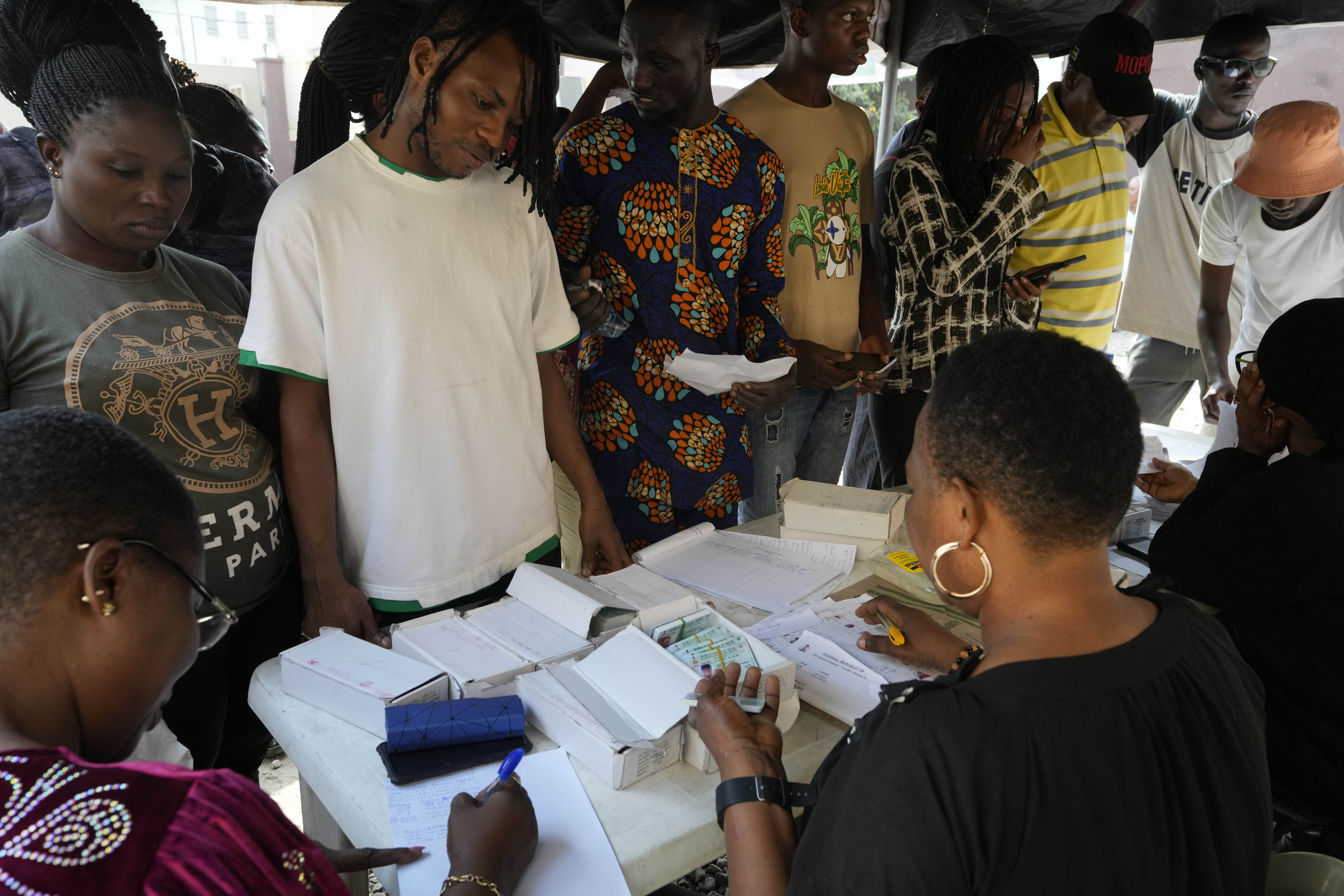 People wait to collect their elections permanent voters card ahead of Feb. 2023 Presidential elections in Lagos, Nigeria, Wednesday, Jan. 11, 2023. (AP Photo/Sunday Alamba)
