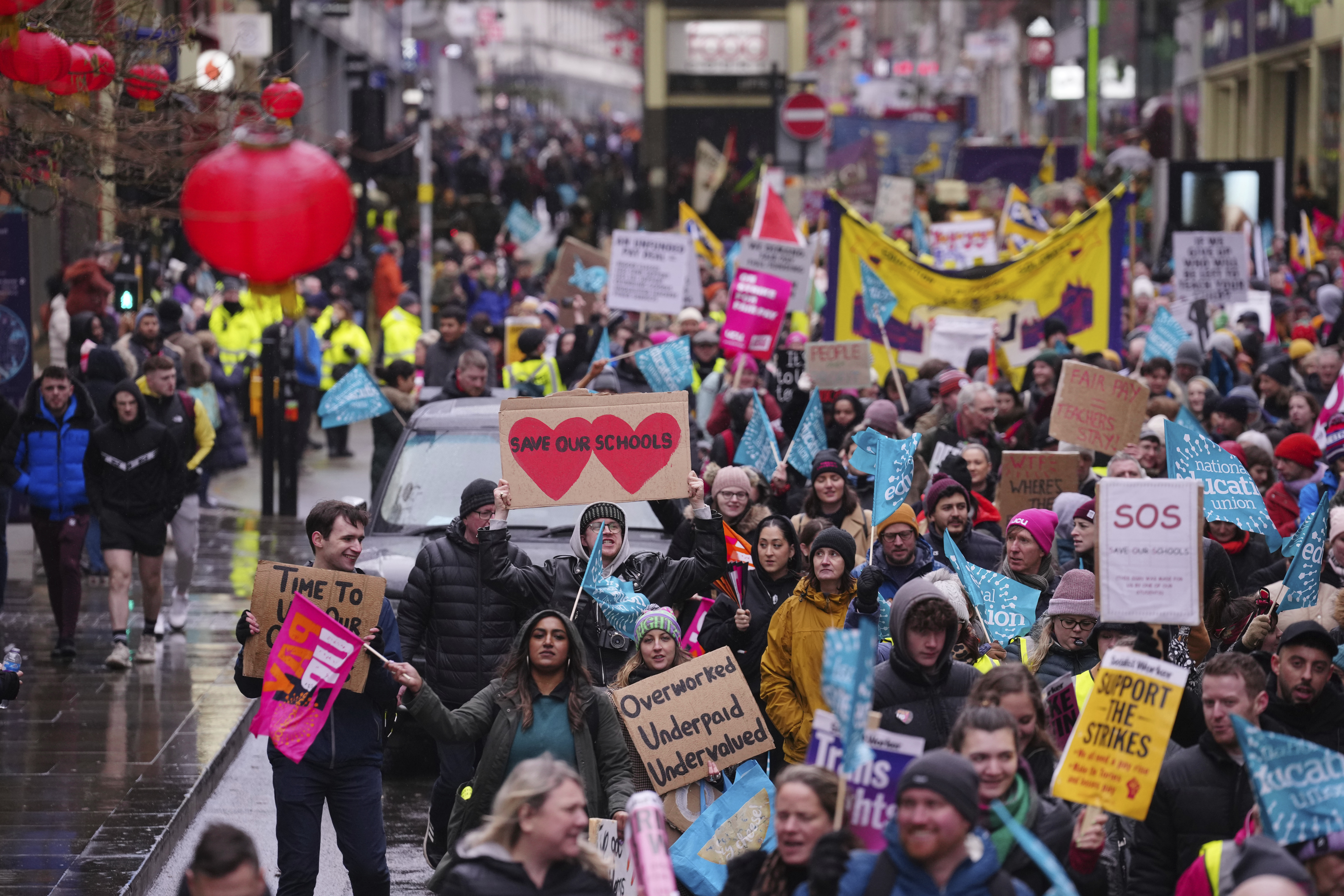 A demonstration in support of strikers is seen in central Manchester, England, Wednesday, Feb. 1, 2023. Up to half a million workers are expected to go on strike across the U.K. in what's shaping up to be the biggest day of industrial action Britain has seen in more than a decade. (AP Photo/Jon Super)