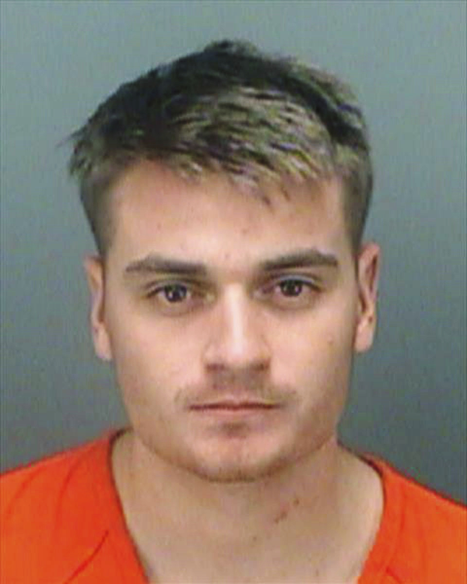 A jail photo of Brandon Russell in an orange uniform