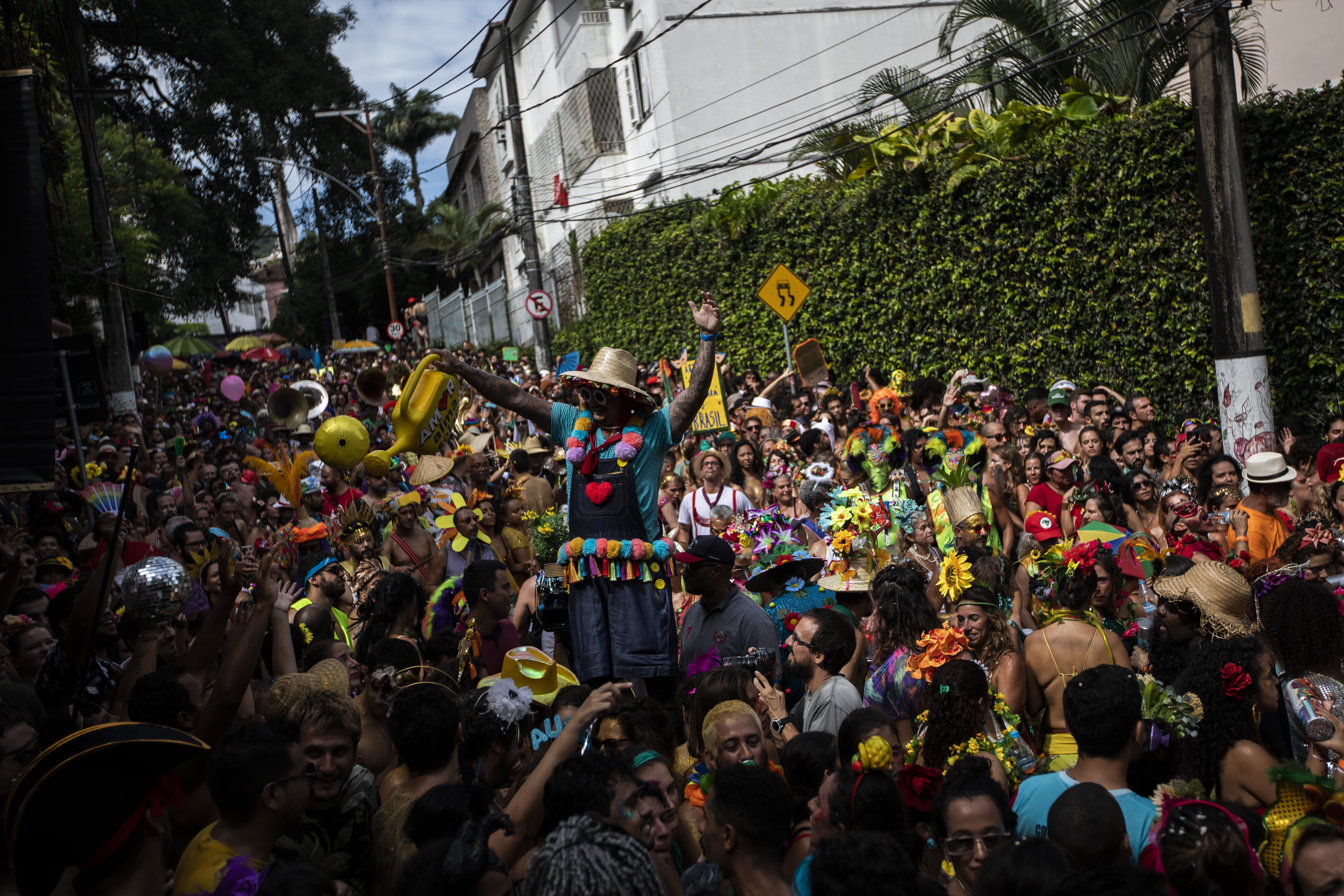 A stilt-walker plies through a crowded street