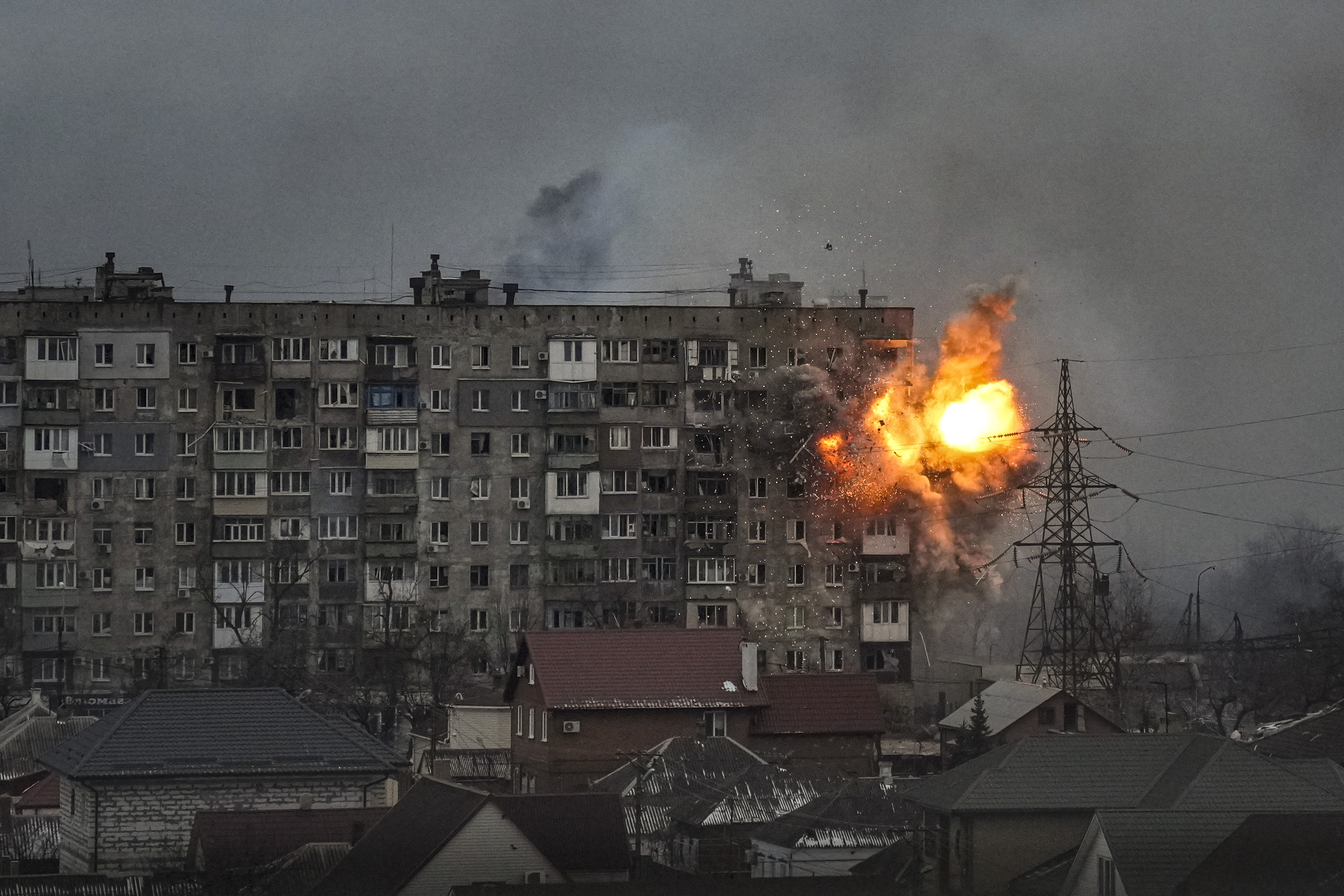 An explosion erupts from an apartment building at 110 Mytropolytska St., after a Russian army tank fired on it in Mariupol