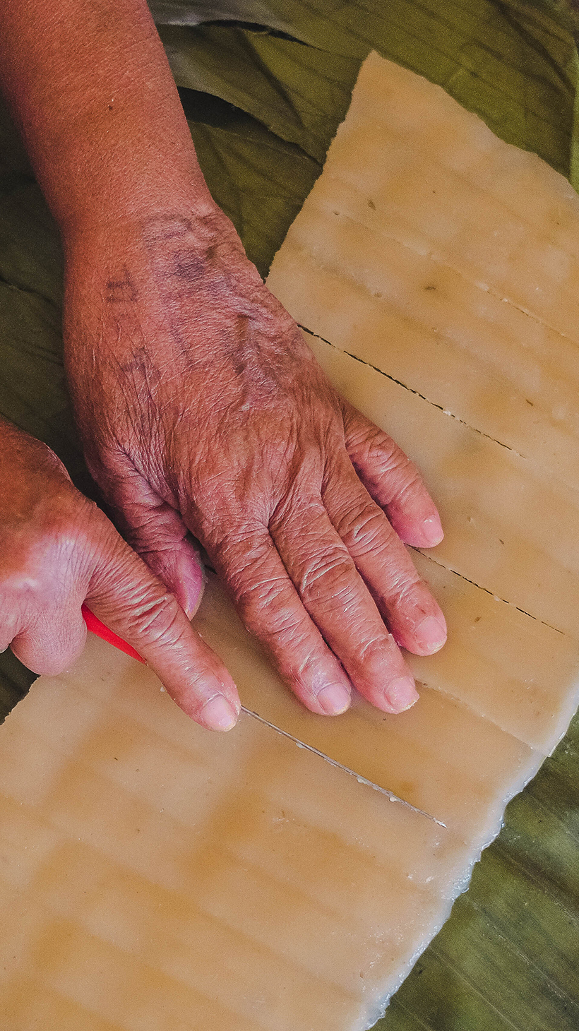 Bekelech's hands as she cuts strips of kocho for toasting
