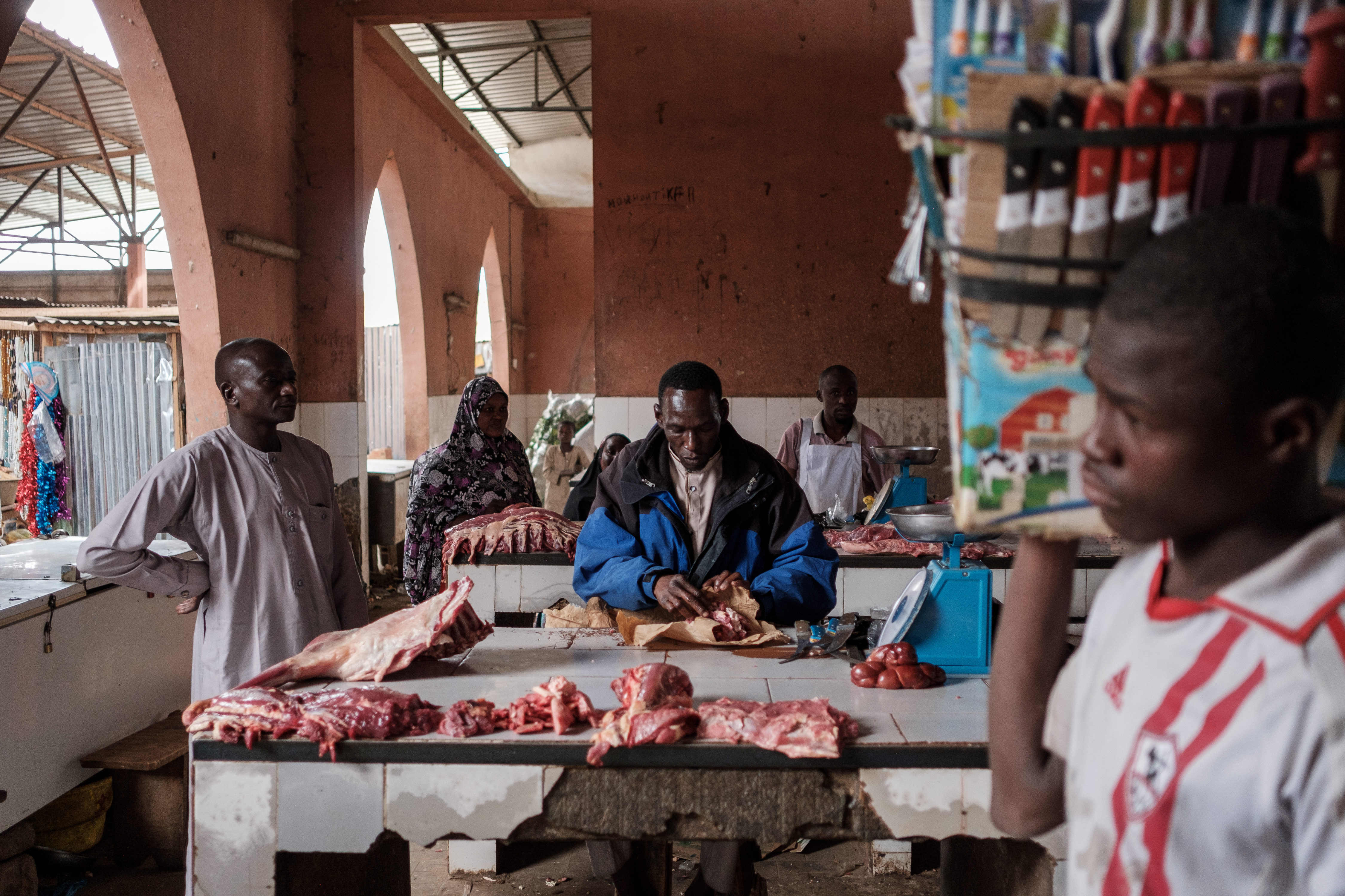 A butcher packs meat at a busy market in Maradi, Niger's second-largest city, in the south of the country on the border with Nigeria [Guy Peterson/Al Jazeera]