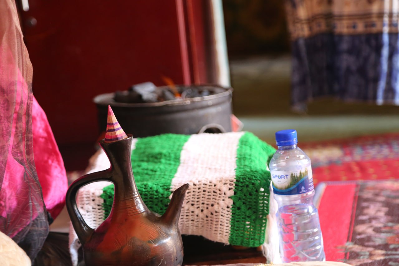 A photo of pot and a plastic bottle of water.
