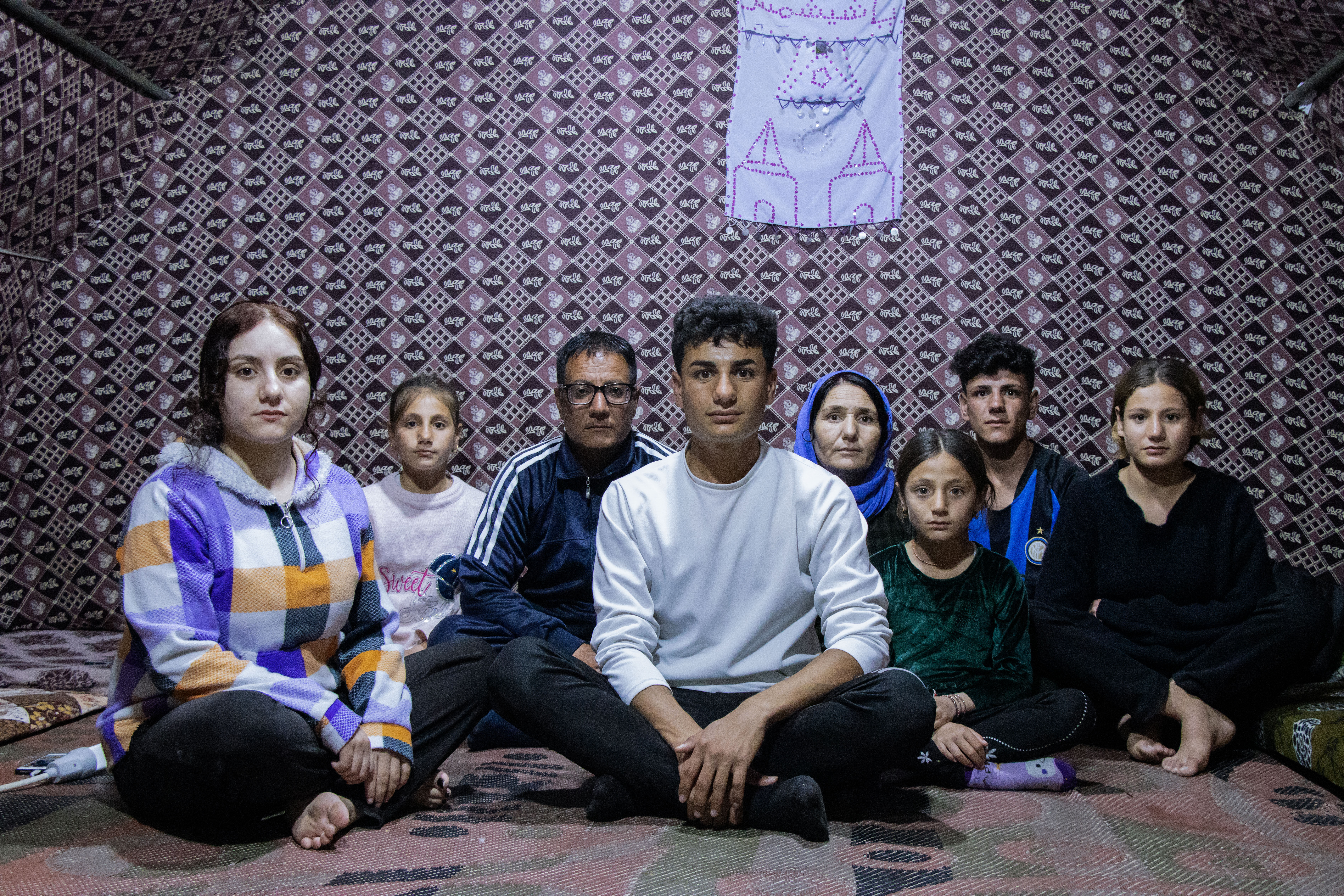 A photo of Nazar sitting in his tent.